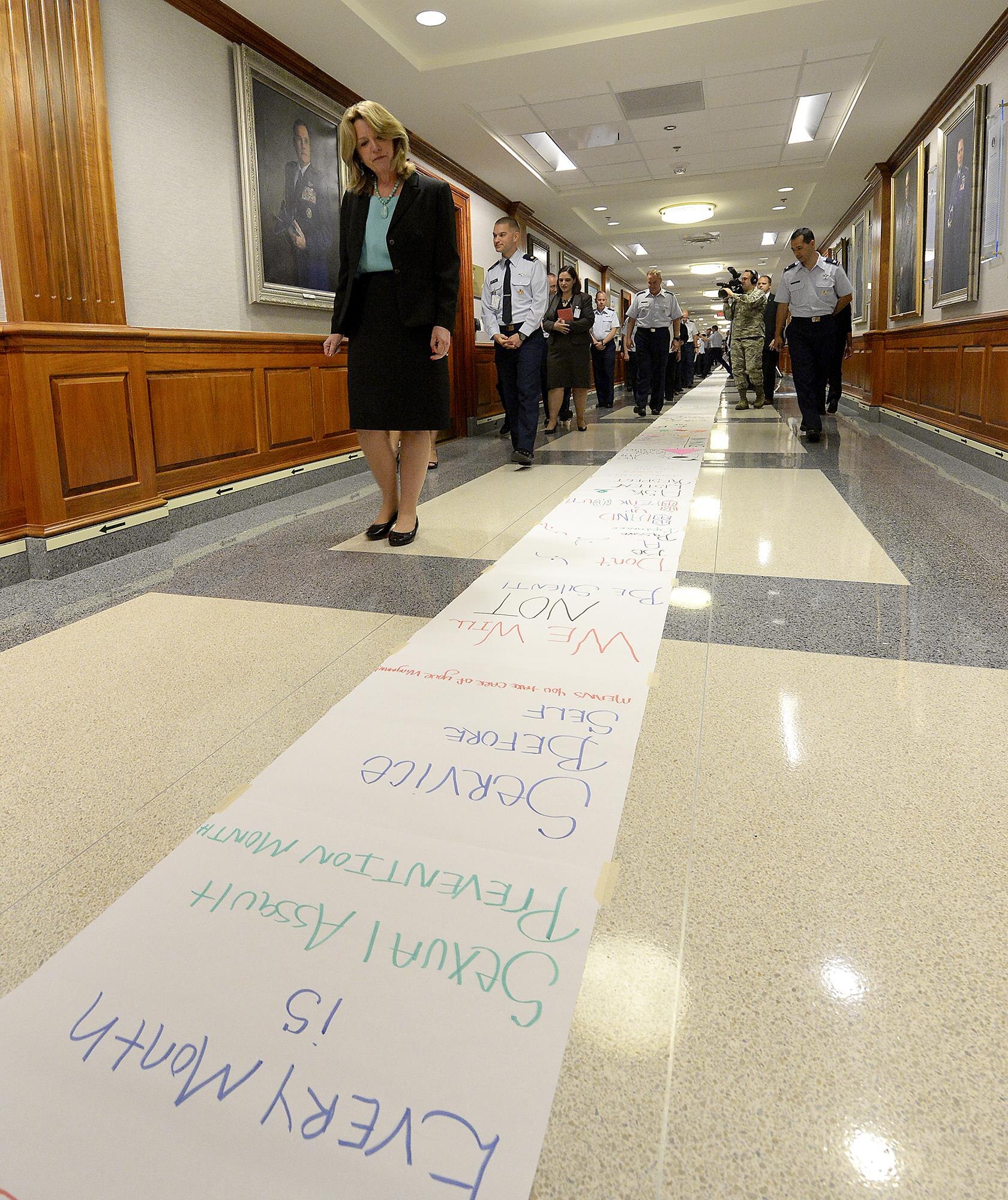 Secretary of the Air Force Deborah Lee James reads messages created by Air Staff members who lined the Arnold Corridor in recognition of Sexual Assault Awareness and Prevention, in the Pentagon, April 20, 2015. The Air Force's senior leaders hosted the short hallway event to send the message, that while the official SAAPM concluded, sexual assault prevention is all year long. (U.S. Air Force photo/Scott M. Ash)