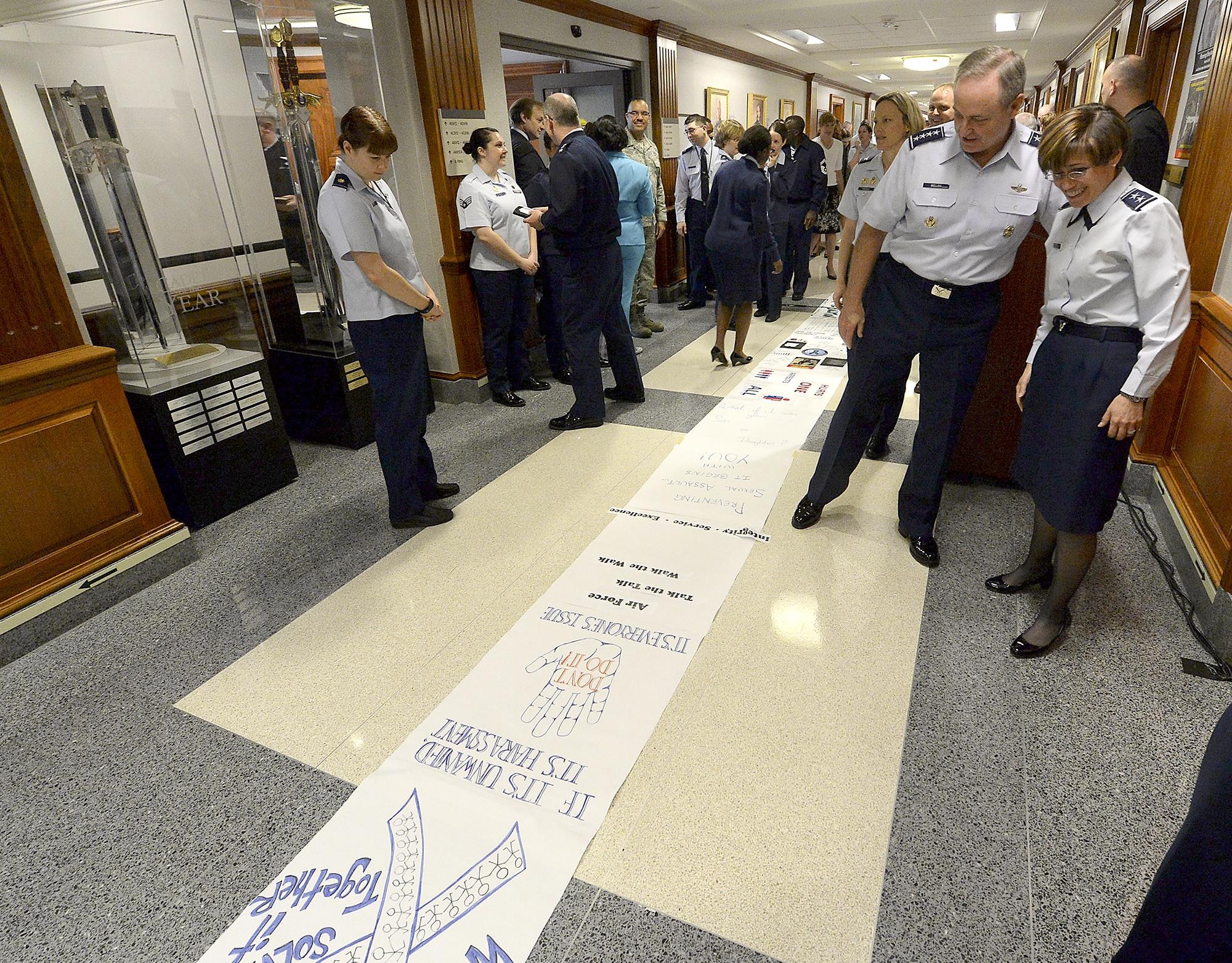 Air Force Chief of Staff Gen. Mark A. Welsh III walks with Maj. Gen. Gina Grosso, the director of the Air Force Sexual Assault and Response, and read messages created by Air Staff members who lined the Arnold Corridor in recognition of Sexual Assault Prevention and Response, in the Pentagon, April 20, 2015. The Air Force's senior leaders hosted the short hallway event to send the message, that while the official SAAPM concluded, sexual assault prevention is all year long. (U.S. Air Force photo/Scott M. Ash)