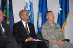 U.S. Attorney General Eric Holder, left, and Air Force Maj. Gen. Michael Dubie, the adjutant general of the Vermont National Guard, right, participated in a deployment ceremony for about 66 members of Company C, 3-126th Aviation of the Vermont Army National Guard. The unit will deploy to Iraq later this year.