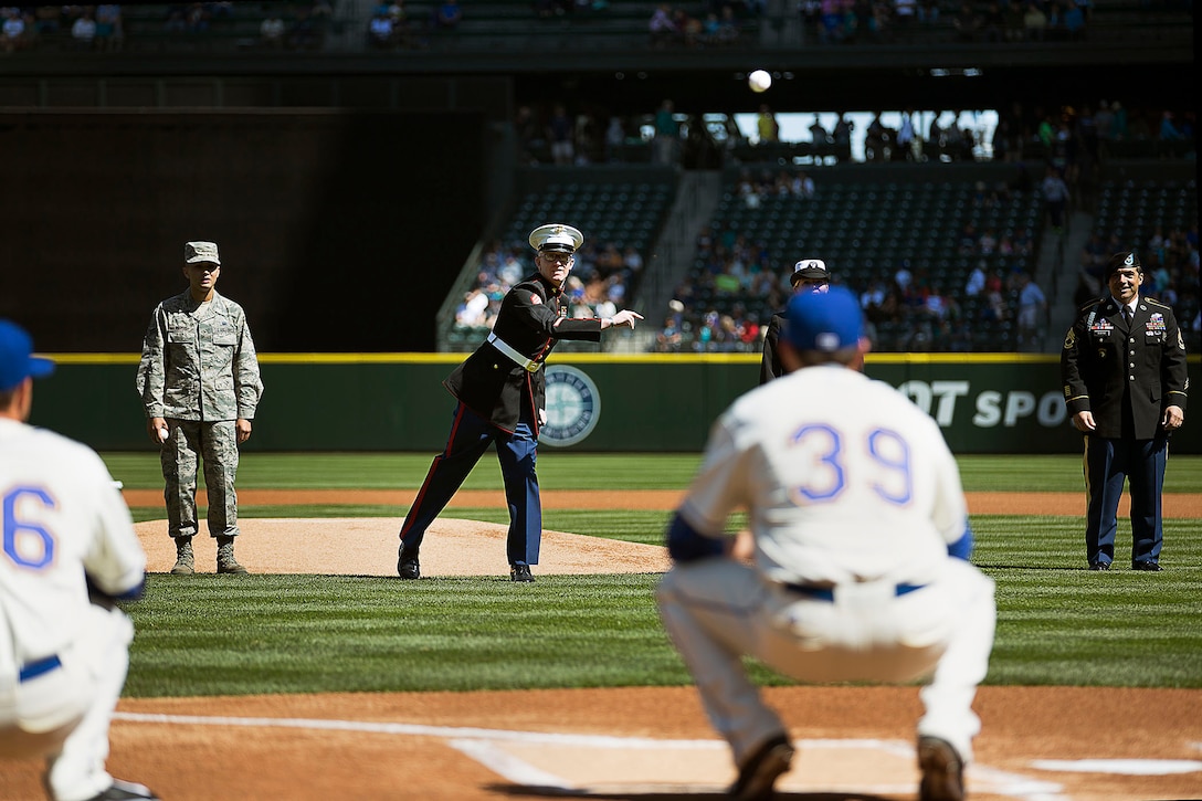 SEATTLE -- Sgt. Sean Wicks, the pool program specialist for Marine Corps Recruiting Station Seattle, throws a ceremonial first pitch before a Seattle Mariners' Salute to Armed Forces game at Safeco Field here, April 19, 2015. The event included the presentation of commemorative plaques to senior military leaders, a joint-service color guard and flag presentation, and military band performances. Wicks, 26, is from Seattle. (U.S. Marine Corps photo by Sgt. Reece Lodder)