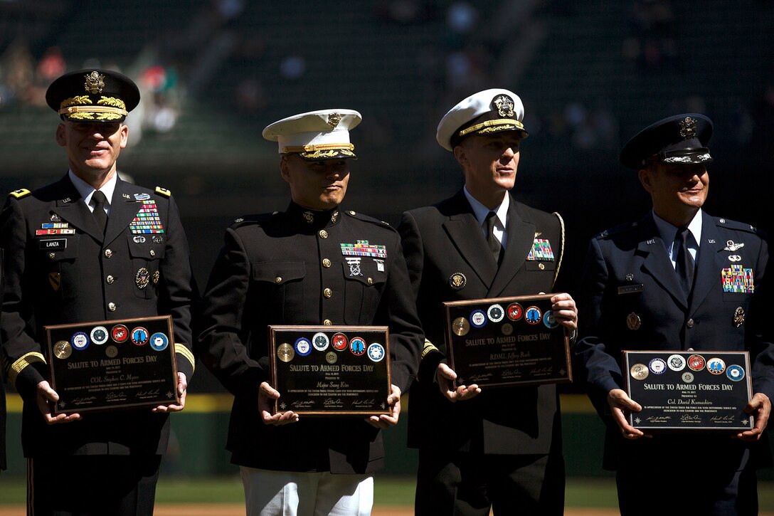 SEATTLE -- Maj. Sung Kim (second from left), the commanding officer of Marine Corps Recruiting Station Seattle, poses with local military leaders after being honored before a Seattle Mariners' Salute to Armed Forces game at Safeco Field here, April 19, 2015. The event included the presentation of commemorative plaques to senior military leaders, a joint-service color guard and flag presentation, military band performances and ceremonial first pitches thrown out by members of each service. (U.S. Marine Corps photo by Sgt. Reece Lodder)