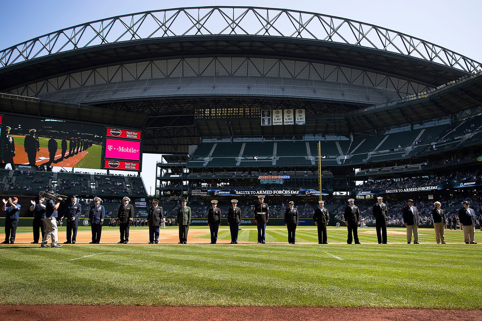 SEATTLE -- Service members from western Washington State line the base paths during the opening ceremonies of a Seattle Mariners' Salute to Armed Forces game at Safeco Field here, April 19, 2015. The event included the presentation of commemorative plaques to senior military leaders, a joint-service color guard and flag presentation, military band performances and ceremonial first pitches thrown out by members of each service. (U.S. Marine Corps photo by Sgt. Reece Lodder)