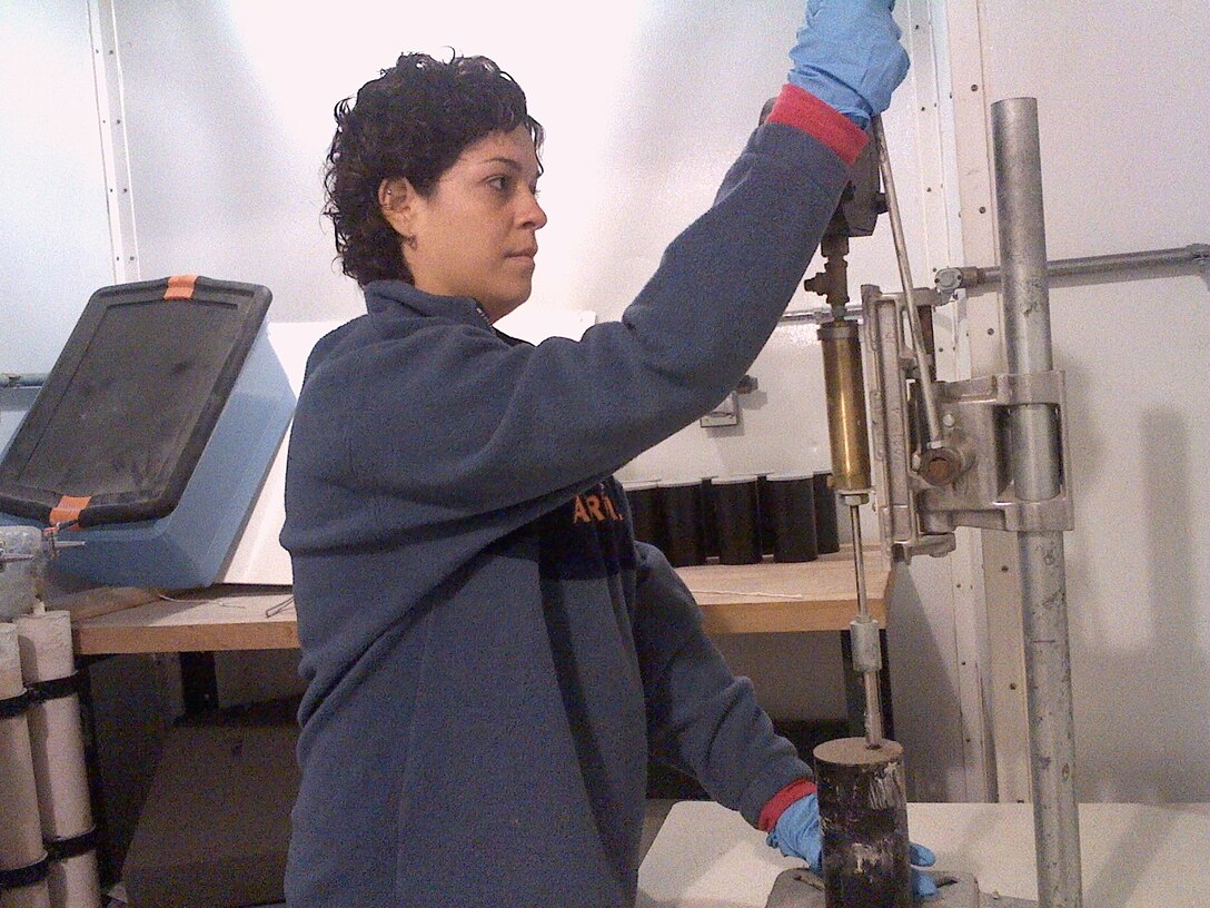 As part of a CRREL student sponsorship program, University of Puerto Rico–Mayaguez (UPRM) student Hildelix Soto tests the early strength of a prototype cold-weather concrete solution in a CRREL cold room.