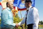 Army Brig. Gen. Mark Anderson, commander of the Wisconsin Army National Guard, congratulates Michael A. Olivas who was awarded a Bronze Star medal with "V" device for valor during a ceremony at Stricker Pond Park in Middleton, Wis., Sept. 14, 2010. The award recognizes Olivas' heroism during an insurgent ambush on a Wisconsin Army National Guard convoy security mission in southern Iraq on Jan. 30, 2005.