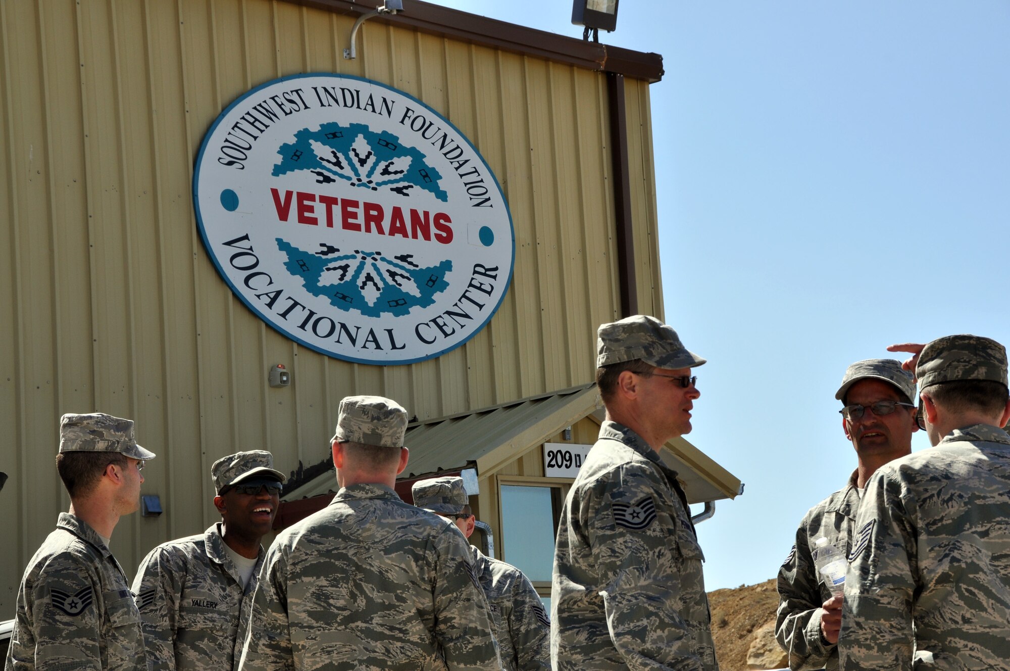 Members of the 911th Civil Engineer Squadron chat while on a break from initial briefings on the first day of Operation Footprint, in Gallup, New Mexico, April 20, 2015. The operation will have around 20 Airmen participating in the construction of homes for the underprivileged of the Navajo Nation. (Photo by Senior Airman Joseph E. Bridge)