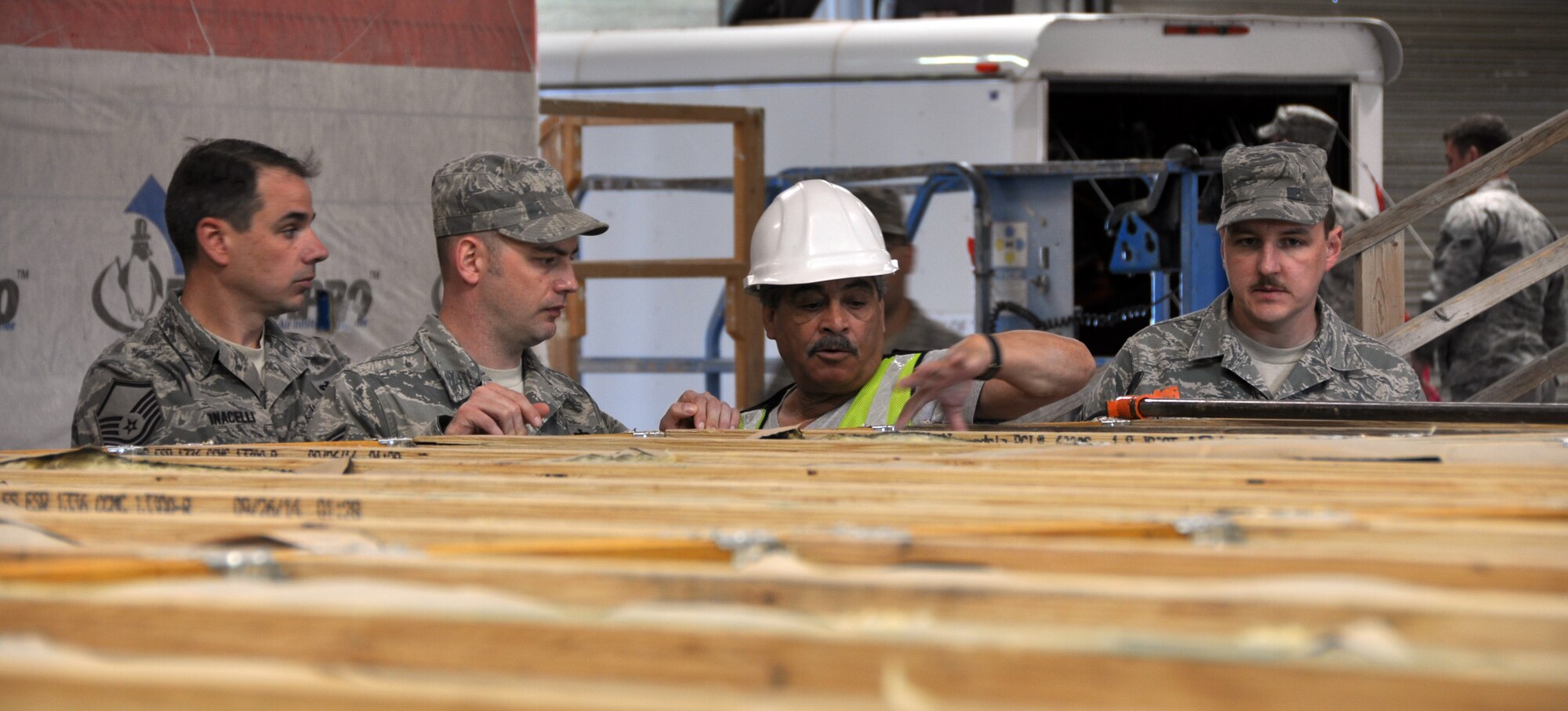 Members of the 911th Civil Engineer Squadron talk with Albert Prieto, the construction project manager of the Southwest Indian Foundation’s Veterans Vocational Center, about construction plans as part of Operation Footprint in Gallup, New Mexico, April 20, 2015. The civil engineers will be in Gallup for approximately two weeks participating in the construction for the underprivileged of the Navajo Nation. (Photo by Senior Airman Joseph E. Bridge)
