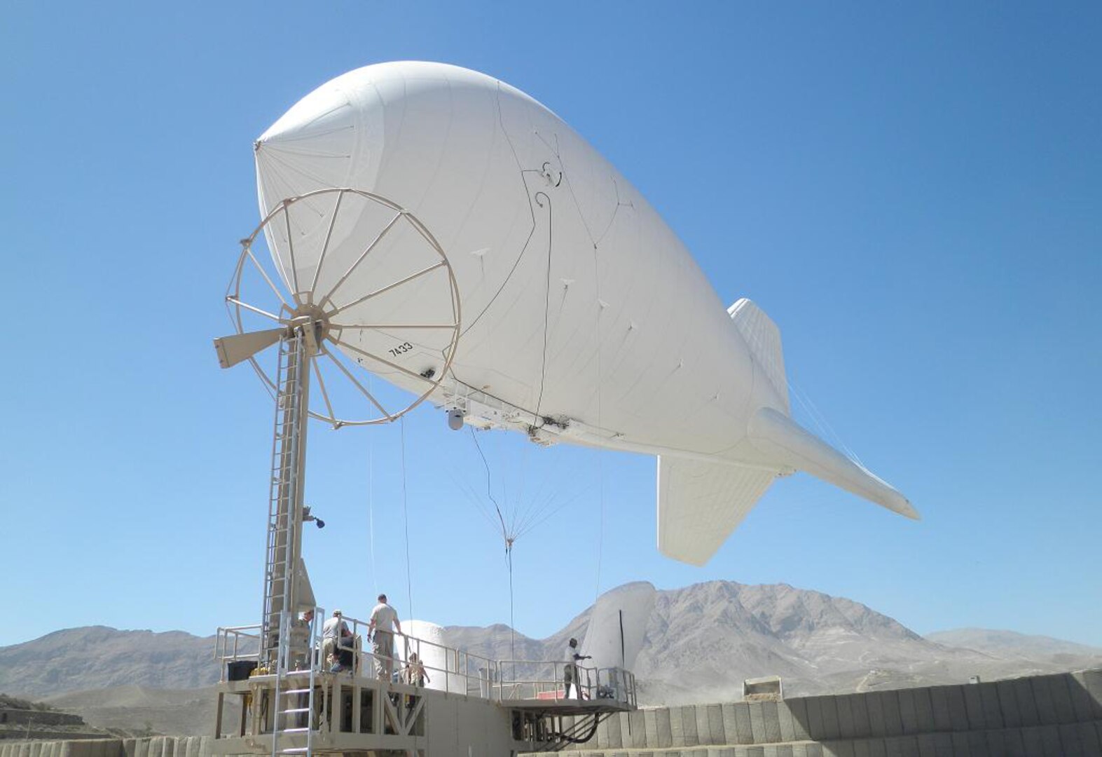 A new Persistent Surveillance System (PSS) begins its assent above Camp Julien Sept. 14, 2010, to provide the Afghan National Security Forces and International Security Assistance Force officials with an extra level of surveillance capability for security operations around Kabul, Afghanistan. The PSS, a floating aerostat (or blimp), has high-tech camera equipment able to provide 360 degree views of the city.