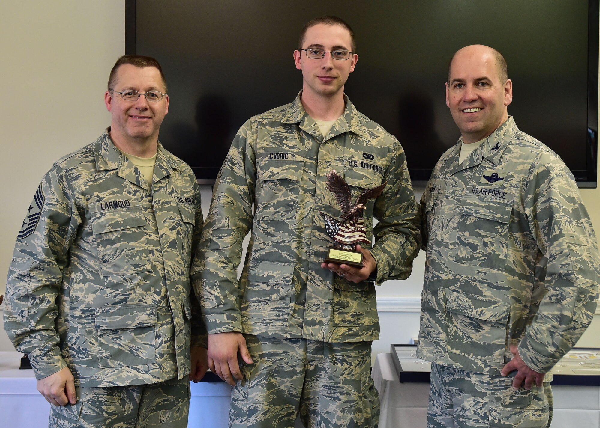 910th Airlift Wing 2014 Airman of the Year, Senior Airman Albin Cvoric, poses with 910th Airlift Wing Command Chief Master Sgt. Steven Larwood and 910th Airlift Wing Commander Col. James Dignan, after receiving his award at a ceremony April 12. Cvoric is a 910th Security Forces fireteam member here. (U.S. Air Force photo/Senior Airman Rachel Kocin)