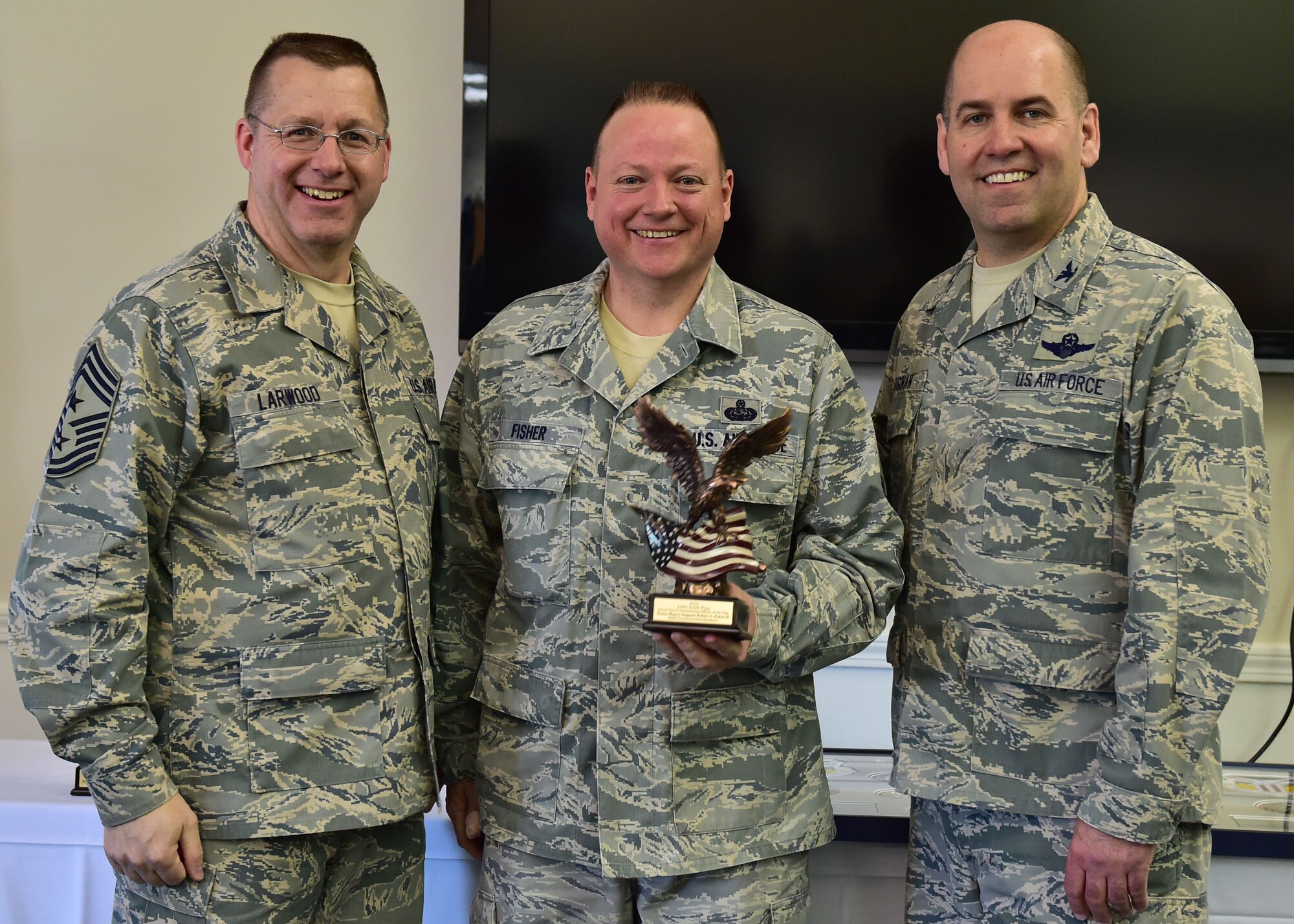 The 910th Airlift Wing's 2014 Senior Non-Commissioned Officer of the Year, Senior Master Sgt. Robert Fisher, poses with 910th Airlift Wing Command Chief Master Sgt. Steven Larwood and 910th Airlift Wing Commander Col. James Dignan, after receiving his award at a ceremony April 12. Fisher is a cyber systems superintendent with the 910th Communications Squadron here. (U.S. Air Force photo/Senior Airman Rachel Kocin)