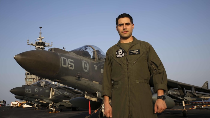 U.S. Marine Corps Capt. Sean M. Stephenson poses for a photo in front of his AV-8B Harrier on the flight deck of the USS Bonhomme Richard (LHD 6) March 17, 2015. Stephenson started out his career as an enlisted band member and then persued his dream of becoming a pilot. Stehenson is a Harrier pilot with Marine Attack Squadron 231, 31st Marine Expeditionary Unit. 