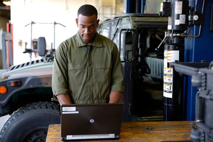 Lance Cpl. Cedric Hargrove enters data into Global Combat Support System-Marine Corps using a laptop in a motor bay at The Basic School aboard Marine Corps Base Quantico, Va. Thanks to a recent GCSS-MC software update, Marines will be able to make better use of the logistics and resource management software system in limited-connectivity environments.