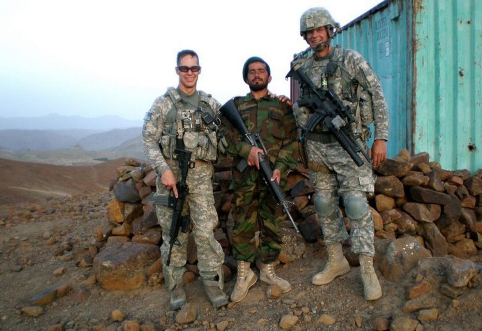 Army Col. Will Roy, left, commander of the Vermont National Guard's 86th Infantry Brigade Combat Team, poses with “Lashkar,” an Afghan army officer, and Vermont National Guard Sgt. Erik K. Morrill in Afghanistan.