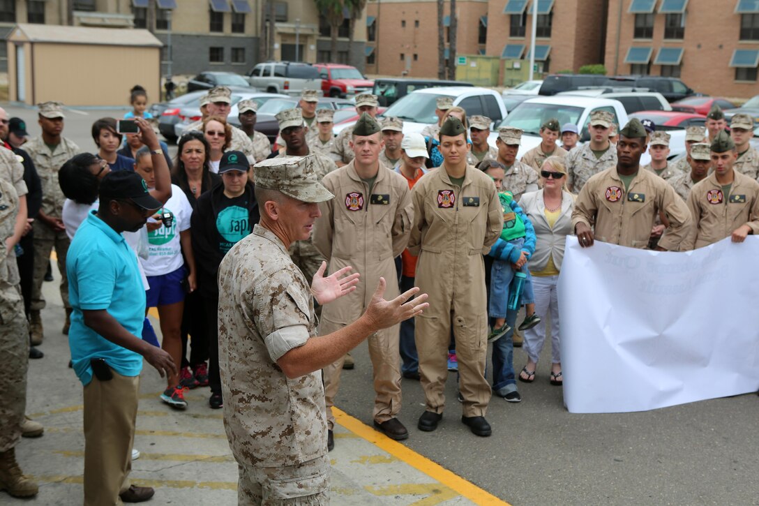 Col. John Farnam, commanding officer of Marine Corps Air Station Miramar, thanks members of the air station for participating in the Sexual Assault Awareness Month Walk aboard MCAS Miramar, California, April 20. The annual event encourages the prevention of sexual assault and related incidents on and off the instillation. (U.S. Marine Corps photo by Sgt. Melissa Wenger/Released)
