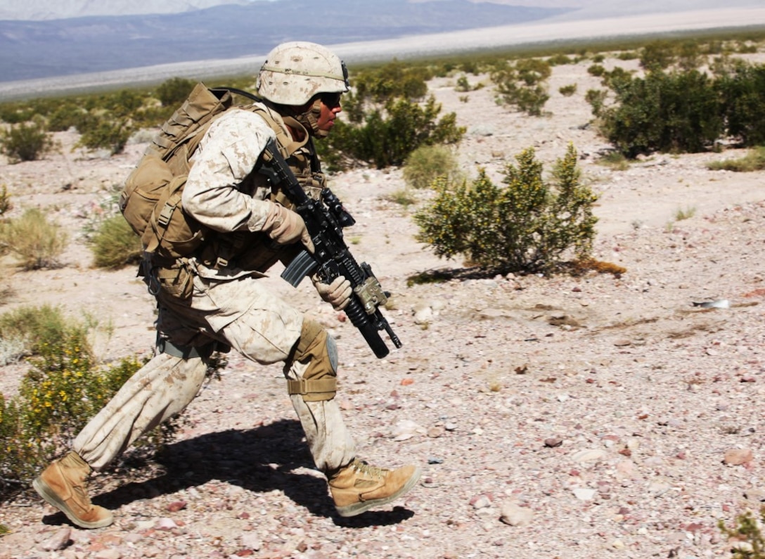 Lance Cpl. Anthony Teyuca, a team leader with Company A, 1st Battalion, 7th Marine Regiment, 1st Marine Division, bounds toward a notional objective during a notional mechanized raid during Exercise Desert Scimitar 15, April 16, 2015. Desert Scimitar is designed to provide tough, realistic live-fire training that allows the 1st Marine Division to improve combat effectiveness and meet current and real-world operational demands.