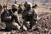 Captain Nicholas J. Freeman (right), commanding officer of Company A, 1st Battalion, 7th Marine Regiment, 1st Marine Division, passes orders over the radio to his Marines during a notional mechanized raid during Exercise Desert Scimitar 15, April 14, 2015. Desert Scimitar is designed to provide tough, realistic live-fire training that allows the 1st Marine Division to improve combat effectiveness and meet current and real-world operational demands.