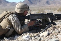 Lance Cpl. Mitchell A. Crawford, machine gunner with Company A, 1st Battalion, 7th Marine Regiment, 1st Marine Division, observes the objective during a notional mechanized raid during Exercise Desert Scimitar 15, April 14, 2015. Desert Scimitar is designed to provide tough, realistic live-fire training that allows the 1st Marine Division to maintain readiness, improve combat effectiveness and meet current and real-world operational demands.