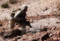 Lance Cpl. Ian M. Madden, a team leader with Company A, 1st Battalion, 7th Marine Regiment, 1st Marine Division, prepares to bound towards an objective during a mechanized raid during Exercise Desert Scimitar 15, April, 15, 2015. Desert Scimitar is designed to provide tough, realistic live-fire training that allows the 1st Marine Division to maintain readiness and meet current and real-world operational demands.