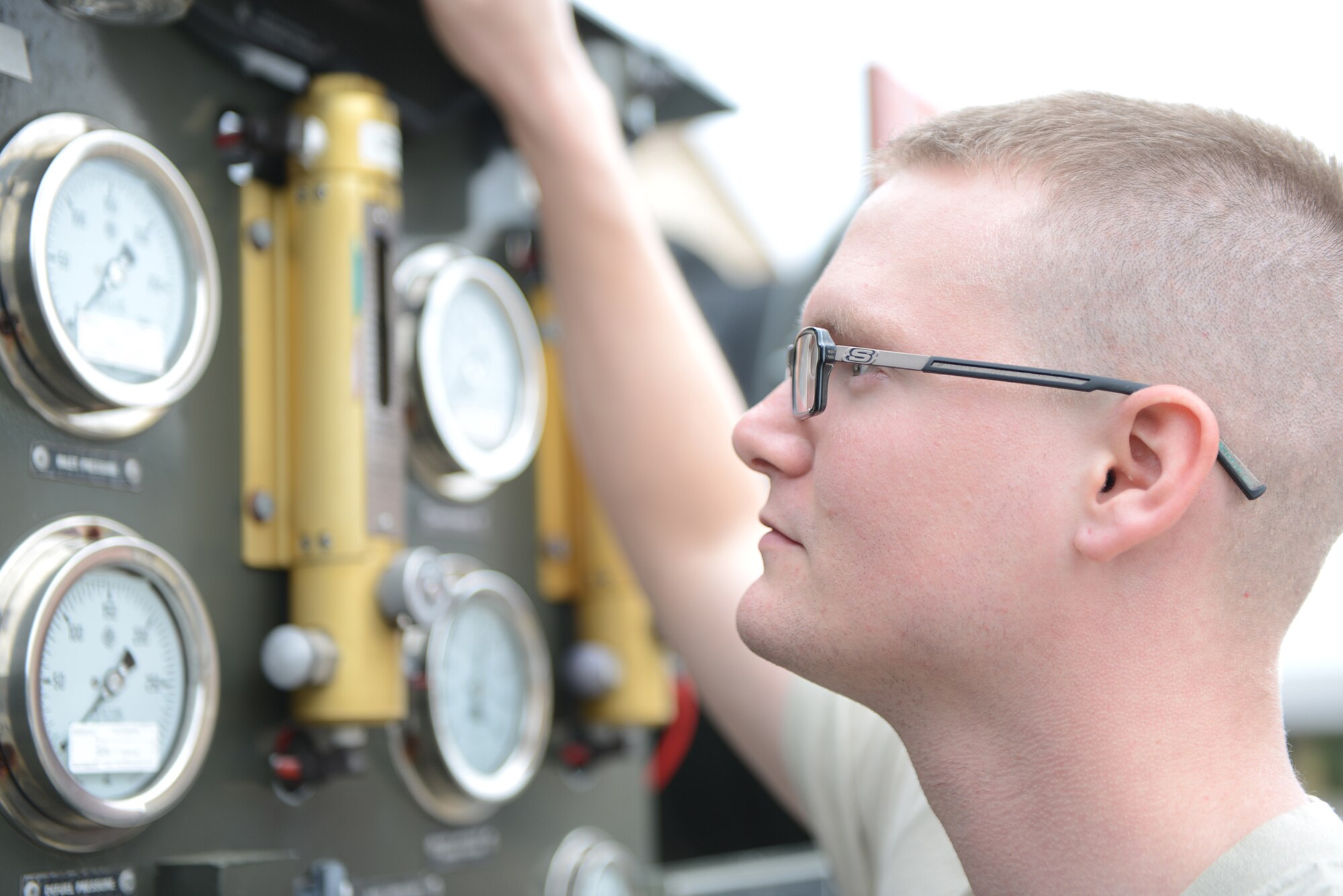 Senior Airman Richard Hurley, 374th Logistics Readiness Squadron lab technician, takes part in a preventative maintenance inspection for an R-11 fuel truck at Yokota Air Base, Japan, April 21, 2015. PMIs are performed daily when the vehicles are in use to prevent fuel leaks or spills. (U.S. Air Force photo by Airman 1st Class David C. Danford/Released)