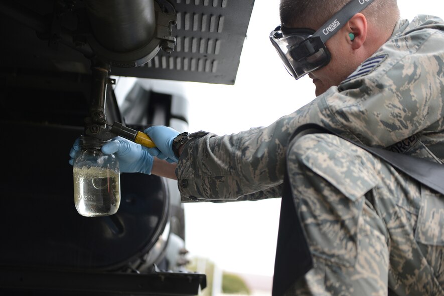 Staff Sgt. Daniel Greene, 374th Logistics Readiness Squadron fuel distribution supervisor, takes a visual sample from an R-11 fuel truck at Yokota Air Base, Japan, April 21, 2015. An R-11 holds a maximum capacity of 6,000 gallons of fuel and is capable of issuing fuel at a rate of 600 gallons per minute. (U.S. Air Force photo by Airman 1st Class David C. Danford/Released)