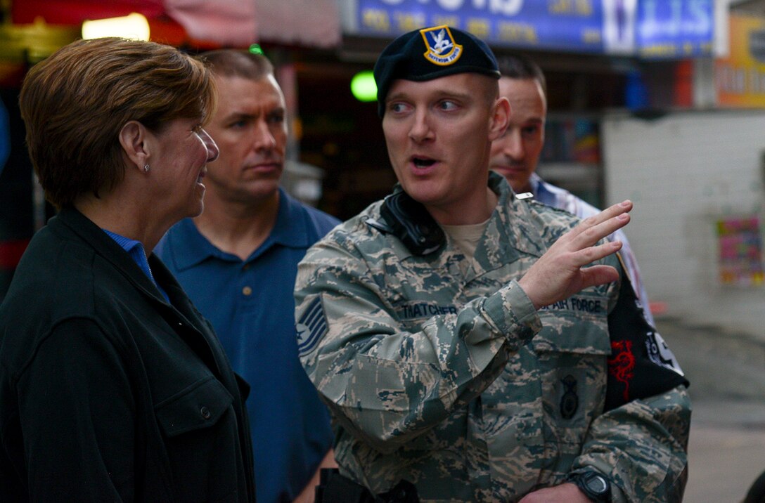 Tech. Sgt. Jeremy Thatcher, 51st Security Forces Town Patrol, talks to Gen. Lori Robinson, Pacific Air Forces commander, about off-limits establishments in the Songtan Entertainment District April 21, 2015, in Pyeongtaek, Republic of Korea. Robinson was learning more about the Town Patrol and their duties as part of her visit to Osan Air Base, ROK. (U.S. Air Force photo by Staff Sgt. Jake Barreiro/Released)