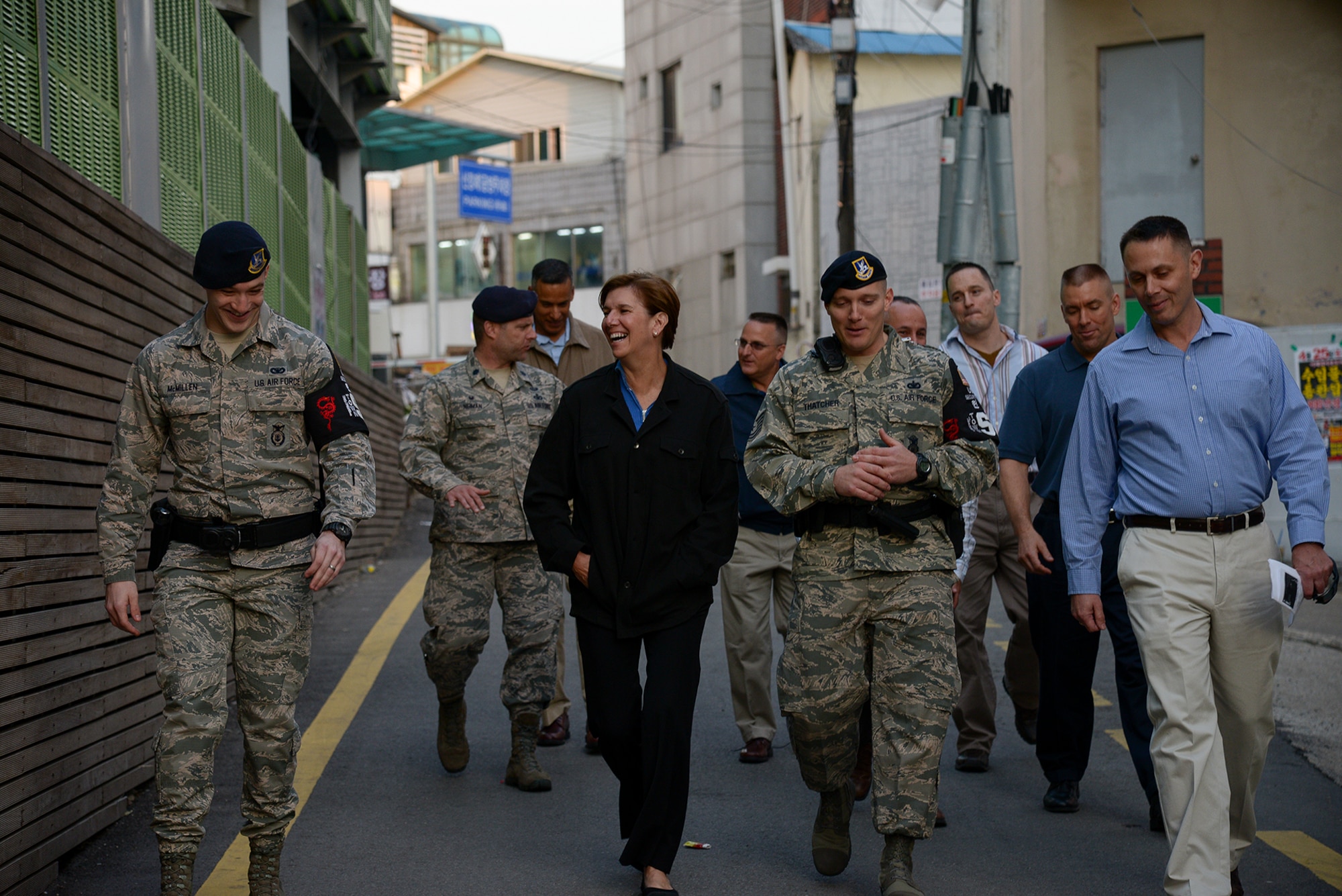 Senior Airman Davis McMillen and Tech. Sgt. Jeremy Thatcher, both members of the 51st Security Forces Squadron Town Patrol, show Gen. Lori Robinson, Pacific Air Forces commander, around the Songtan Entertainment District April 21, 2015, in Pyeongtaek, Republic of Korea. Robinson was visiting the SED to learn more about the mission of Osan Air Base, ROK, which extends into the community outside the gate. (U.S. Air Force photo by Staff Sgt. Jake Barreiro/Released)