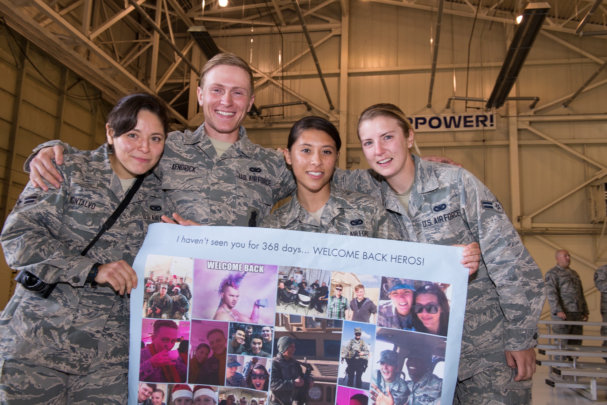 U.S. Air Force Airman 1st Class Sidney Montalvo, left, welcomes her fellow 822nd Base Defense Squadron fire team members back from a deployment April 21, 2015, at Moody Air Force Base, Ga. These Airmen completed their first deployment. (U.S. Air Force photo by Airman Greg Nash/Released)