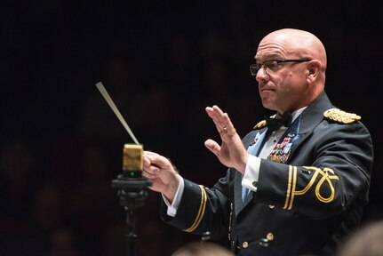 Chief Warrant Officer 4 Thomas W. Hager, United States Army guest conductor, directs U.S. Air Force Band of the West members during the annual Fiesta in Blue concert April 21 at Trinity University’s Laurie Auditorium in San Antonio, Texas. The Air Force’s Band of the West is headquartered at Joint Base San Antonio-Lackland and the band has been a part of Fiesta San Antonio events for more than 20 years.  The objective of the Air Force Bands program is to inspire patriotism and encourage young men and women to serve in the Air Force and other branches of the military.  The Air Force Bands Program is a family of 10 active-duty Air Force bands and five Air National Guard bands. Each band operates within its own geographic area of responsibility representing America's Airmen to a global audience. (U.S. Air Force photo by Airman 1st Class Stormy Archer/released)