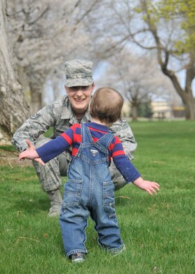 Staff Sgt. Alisha Moore, 92nd Comptroller Squadron financial analysis supervisor, welcomes her foster son with open arms April 13, 2015, at Miller Park on Fairchild Air Force Base, Wash. Moore became a foster parent because of her passion for working with children. She has started a Foster Parent Support Group to share all of the information she has learned in the process of becoming a foster parent. (U.S. Air Force photo/Airman 1st Class Taylor Bourgoeus)