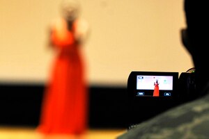 A U.S. Air Force Airman records Rondi Johnson, wife of U.S. Air Force Master Sgt. Neco Johnson, perform “Listen” durng Operation: Talent Search at Langley Air Force Base, Va., April 17, 2015. Johnson came in first place in her age group and category. (U.S. Air Force photo by Senior Airman Breonna Veal/Released) 