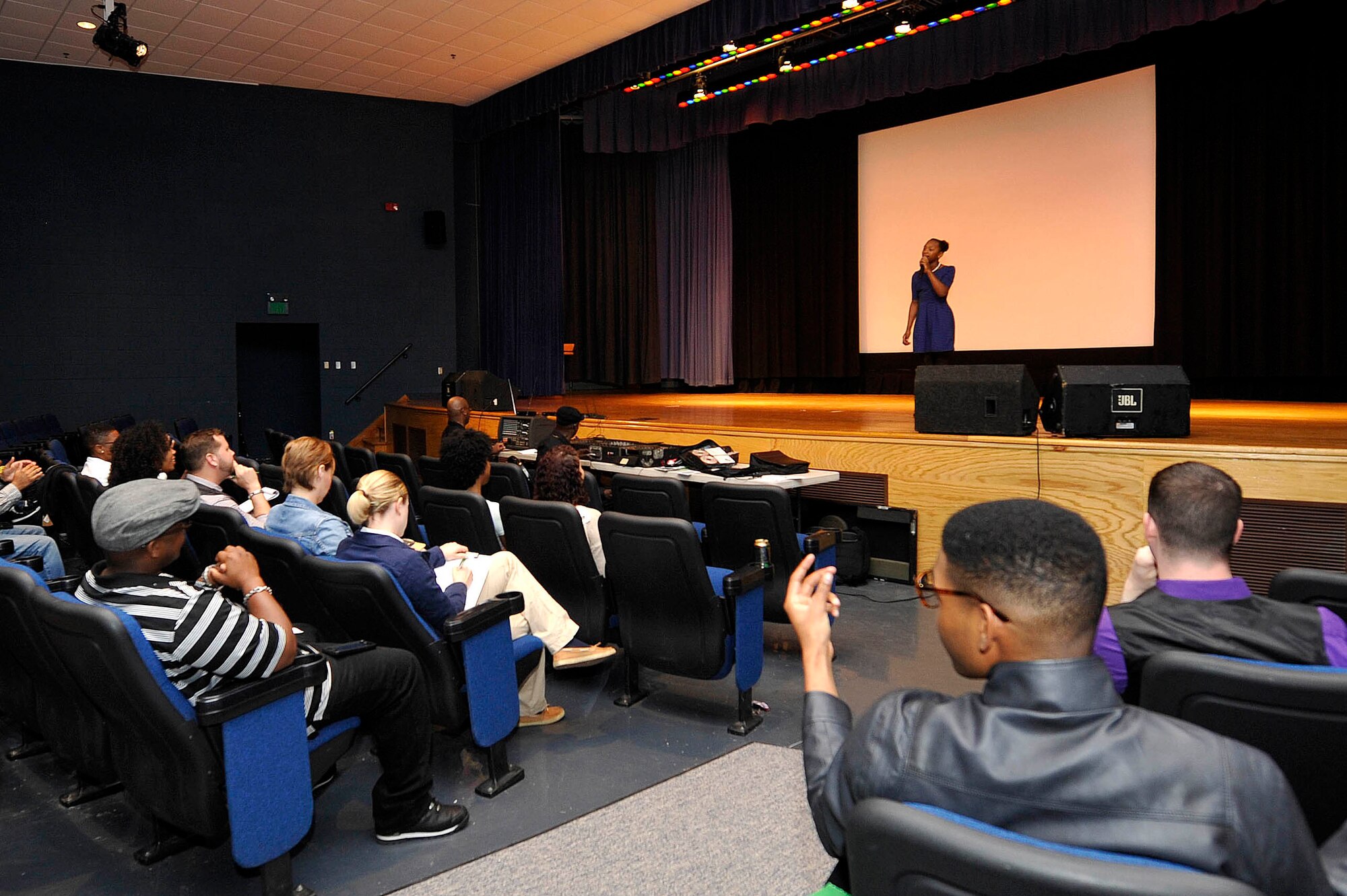 U.S. Service members and family members listen to Kaniya Chapman, daughter of U.S. Air Force Staff Sgt. Jeffery Johnson, sing “My God is Awesome” during Operation: Talent Search at Langley Air Force Base, Va., April 17, 2015. Family members and dependents were also encouraged to participate in the event. (U.S. Air Force photo by Senior Airman Breonna Veal/Released)