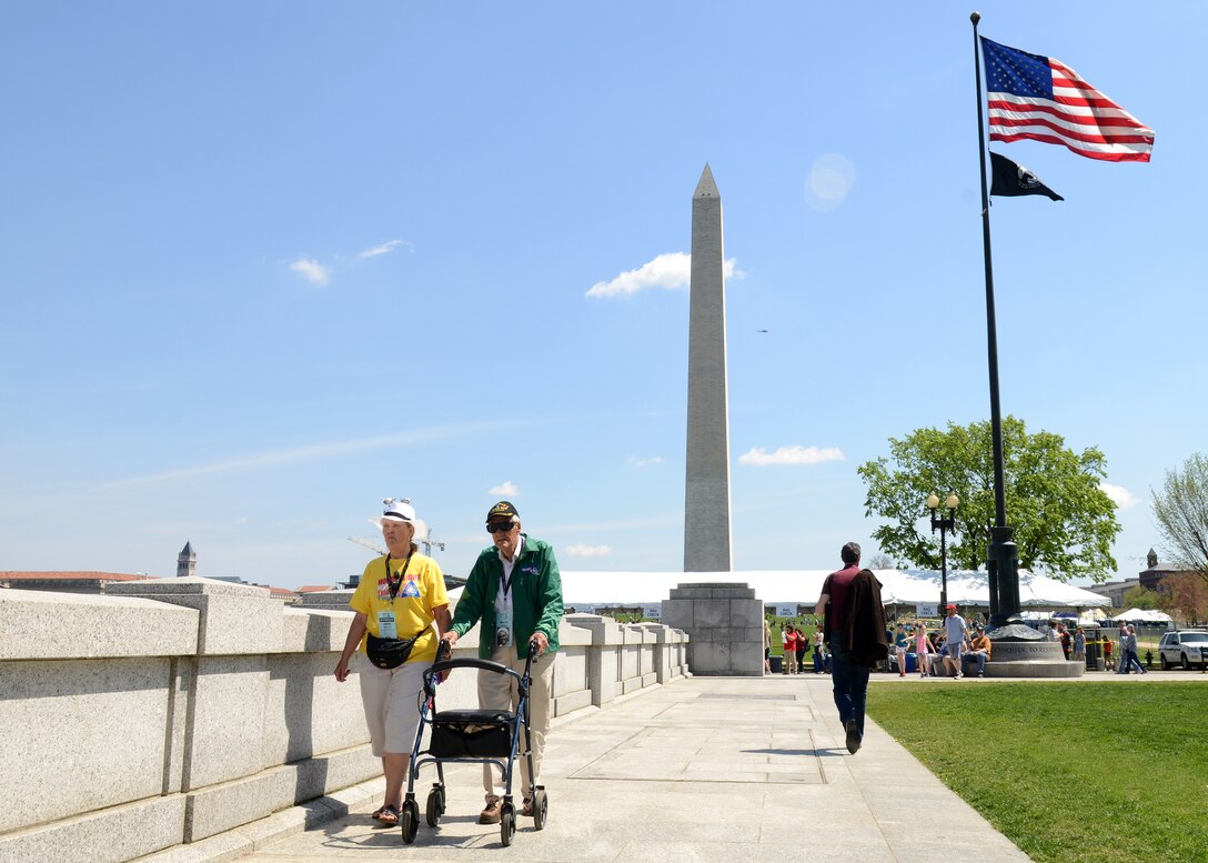 Richard Berrien, U.S. Navy World War II veteran, walks with his guardian near the National World War II Memorial in Washington, D.C., April 18, 2015. Berrien visited the memorial as part of an Honor Flight trip for WWII and Korean War veterans. (U.S. Air Force photo by Airman 1st Class Devin S. Michaels/Released)