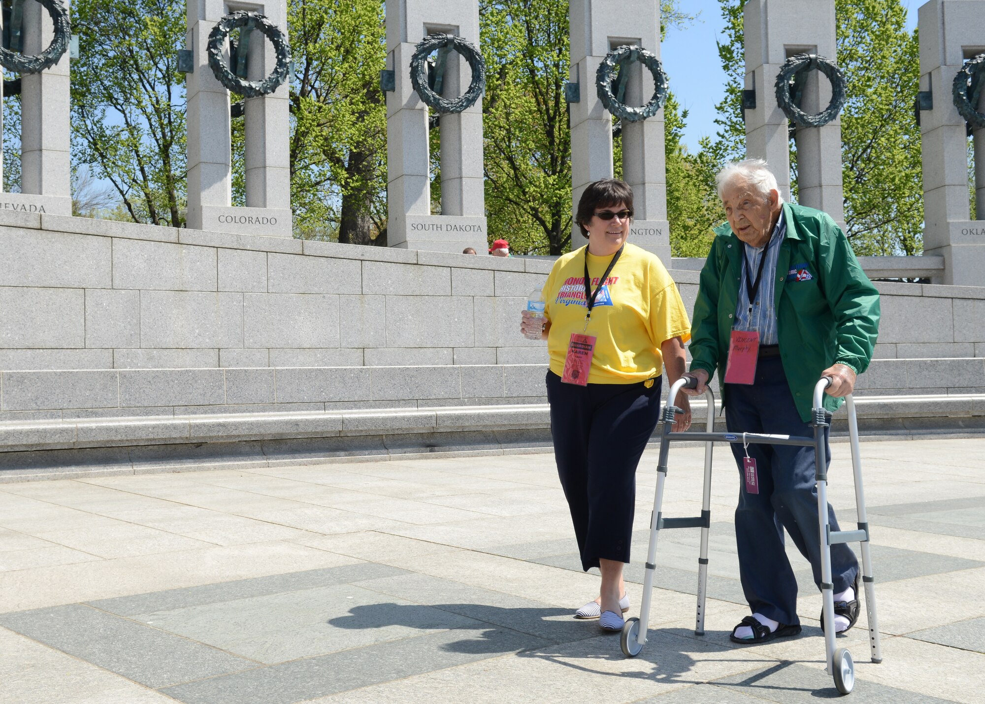 Vincent Murphy, U.S. Army World War II veteran, and his escort walk through the National World War II Memorial in Washington, D.C., April 18, 2015. Murphy was an infantry motors troop from 1944 to 1946. (U.S. Air Force photo by Airman 1st Class Devin S. Michaels/Released)