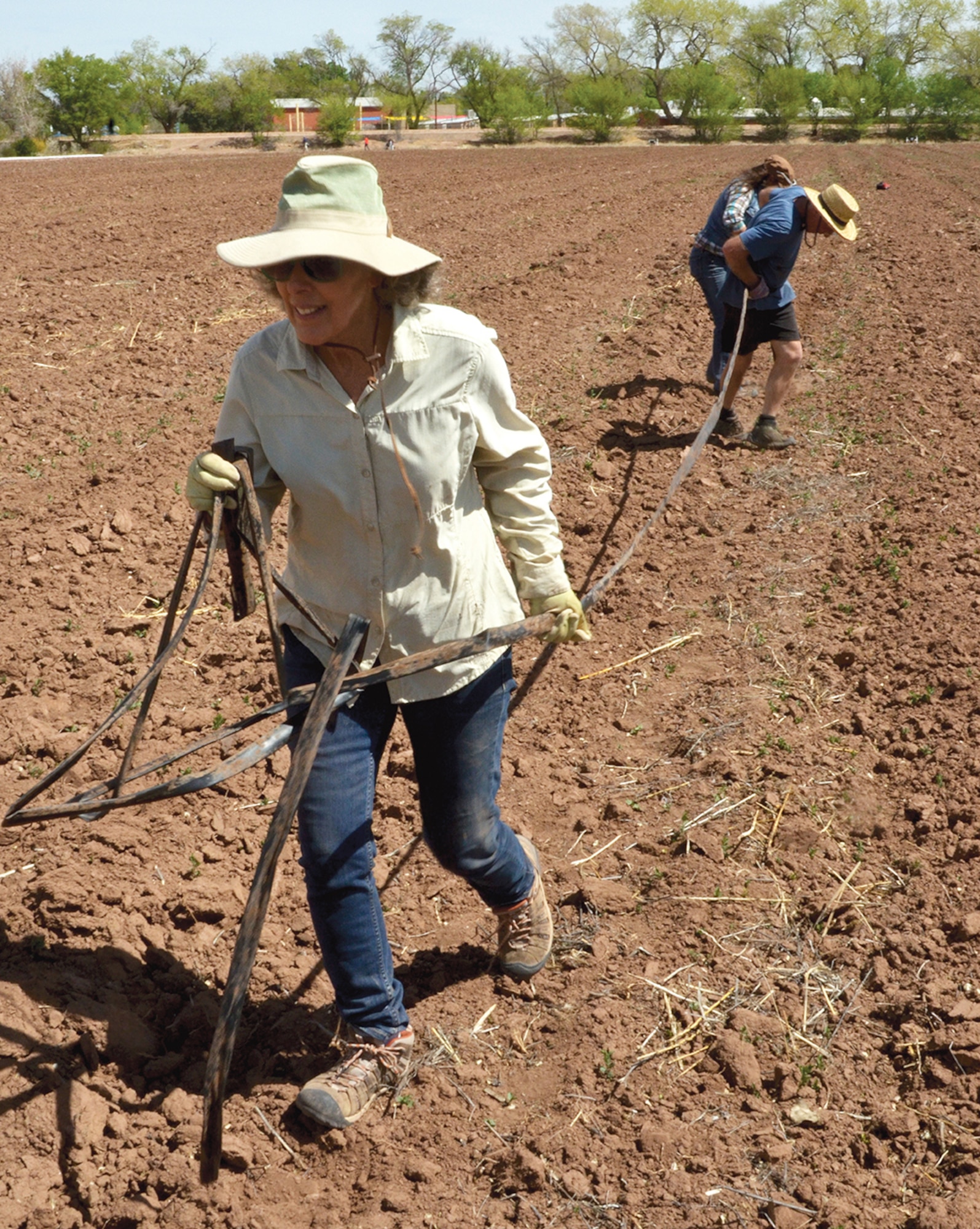 Robin Seydel, the organizer of the Veteran Farmer Project, helps pull irrigation lines at Rio Grande Community Farm. The Veteran Farmer Project provides the initial training for veterans to work in a sustainable agriculture businesses and a chance to put their hands in the soil at a therapeutic garden space. (Photo by Lee Ross)