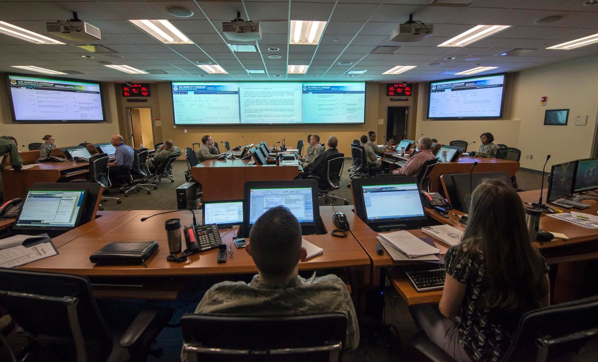 Squadron Airmen and civilians man the Emergency Operations Center April 21, 2015, at Joint Base Charleston, S.C., during a Hurricane Exercise. The EOC is a centralized command and control facility responsible for providing strategic decisions during disasters or emergencies. (U.S. Air Force illustration/Senior Airman Jared Trimarchi)  