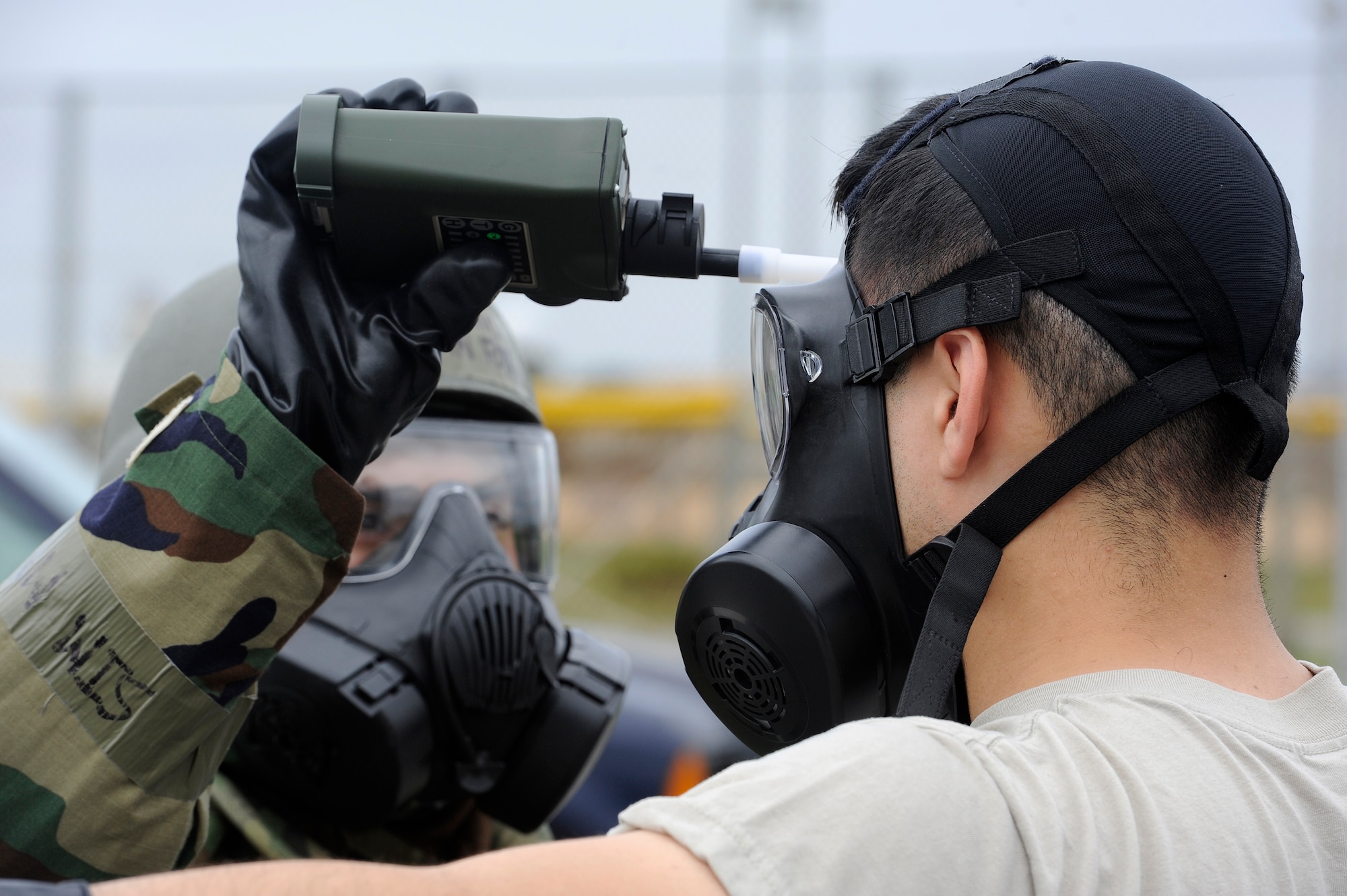 U.S. Air Force Airman 1st Class Ethan Fox, 18th Aircraft Maintenance Squadron, Chemical, Biological, Radiological, Nuclear and Explosives team member, uses contamination monitoring equipment on an Airman from the 18th Mission Support Group during Exercise Beverly High 15-2 on Kadena Air Base, Japan, April 22, 2015. The CBRNE team allowed the Airmen to quickly remove their simulated contaminated gear and get new gear to continue the mission. (U.S. Air Force photo by Staff Sgt. Marcus Morris)