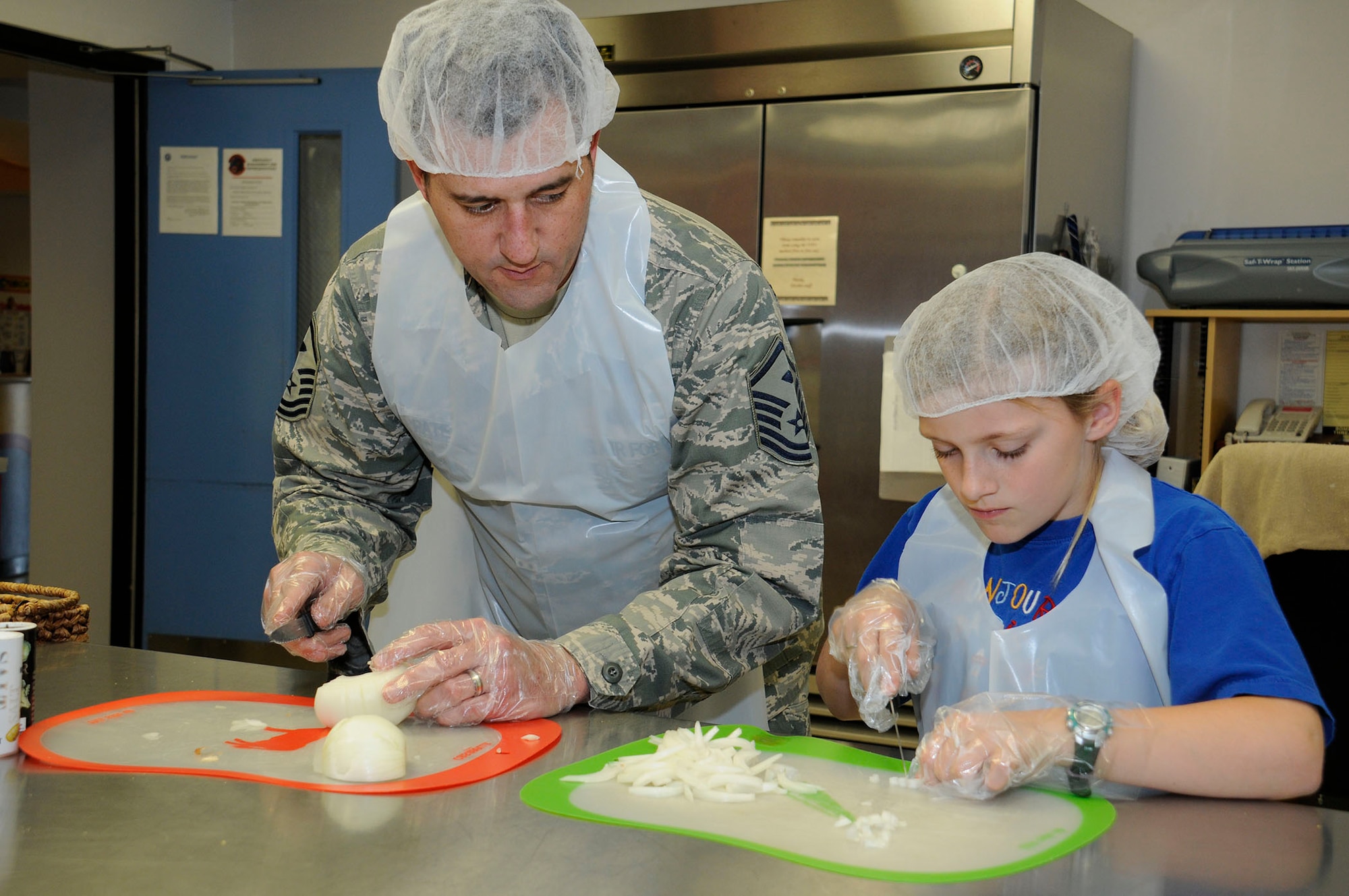 Master Sgt. Zachary Pate, 61st ABG First Sergeant, participates with base housing children in the Home Cooking Club at the Youth Center at Fort MacArthur on April 16. The 61st Force Support Squadron offers a variety of activities throughout the year, but especially this month, as April is the “Month of the Military Child.” (U.S Air Force photo by Joe Juarez)