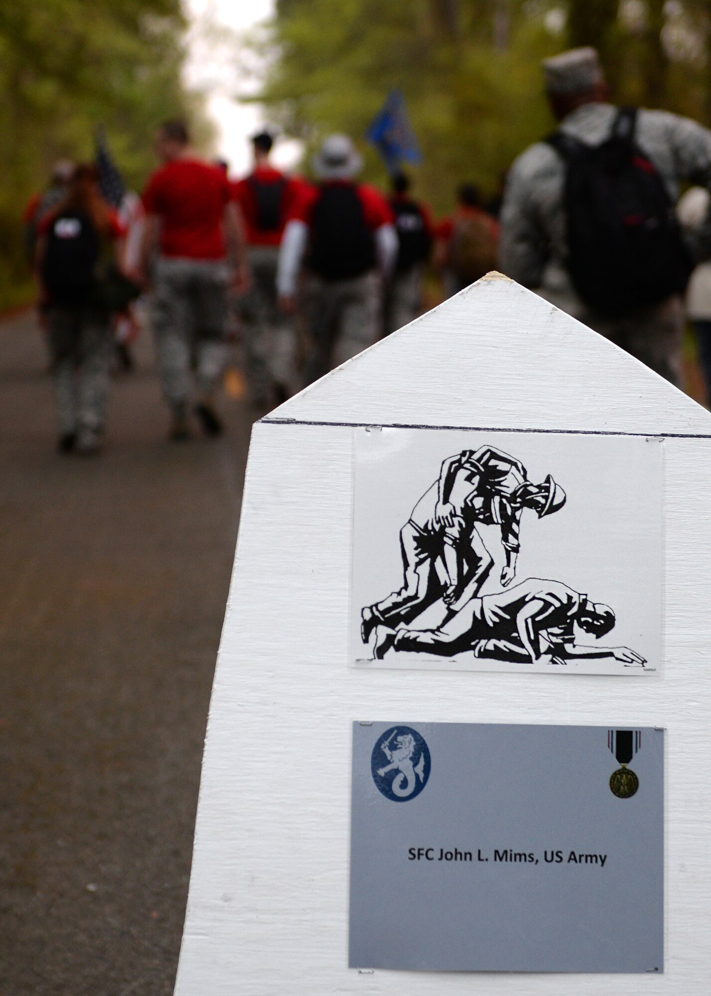 U.S. Air Force Airmen pass the first mile marker during the Bataan Death March in Chesapeake, Va., April 18, 2015. Each mile marker include the names of U.S. Service member Prisoners of War where were a part of the original Bataan Death March through the jungles of the Philippines in 1942. (U.S. Air Force photo by Staff Sgt. Teresa J. Cleveland/Released