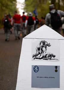 U.S. Air Force Airmen pass the first mile marker during the Bataan Death March in Chesapeake, Va., April 18, 2015. Each mile marker include the names of U.S. Service member Prisoners of War where were a part of the original Bataan Death March through the jungles of the Philippines in 1942. (U.S. Air Force photo by Staff Sgt. Teresa J. Cleveland/Released