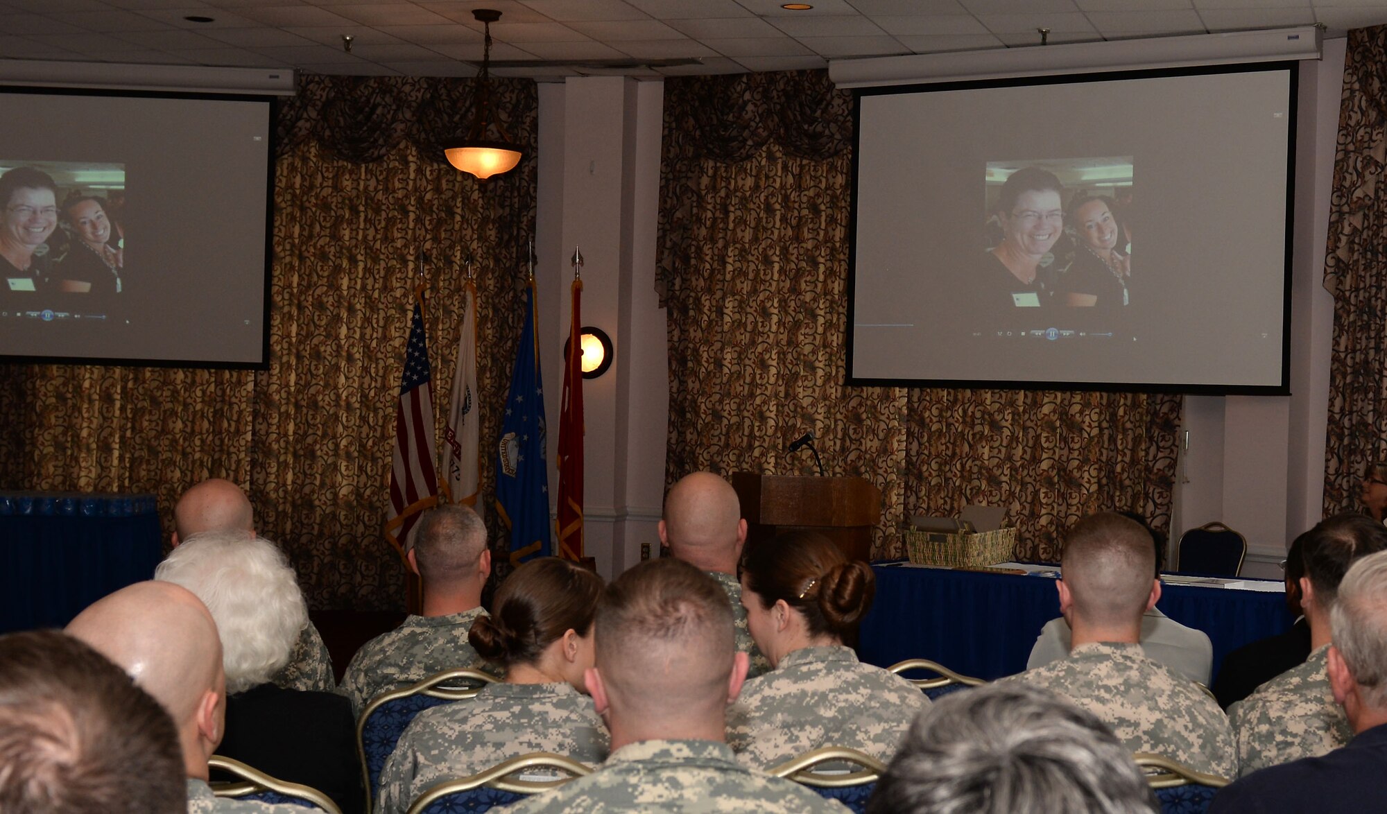 Audience members watch a video highlighting volunteers during a ceremony at Fort Eustis, Va., April 15, 2015. During the ceremony, the Army Volunteer Corps recognized community members for their commitment to service. (U.S. Air Force photo by Staff Sgt. Teresa J. Cleveland/Released)