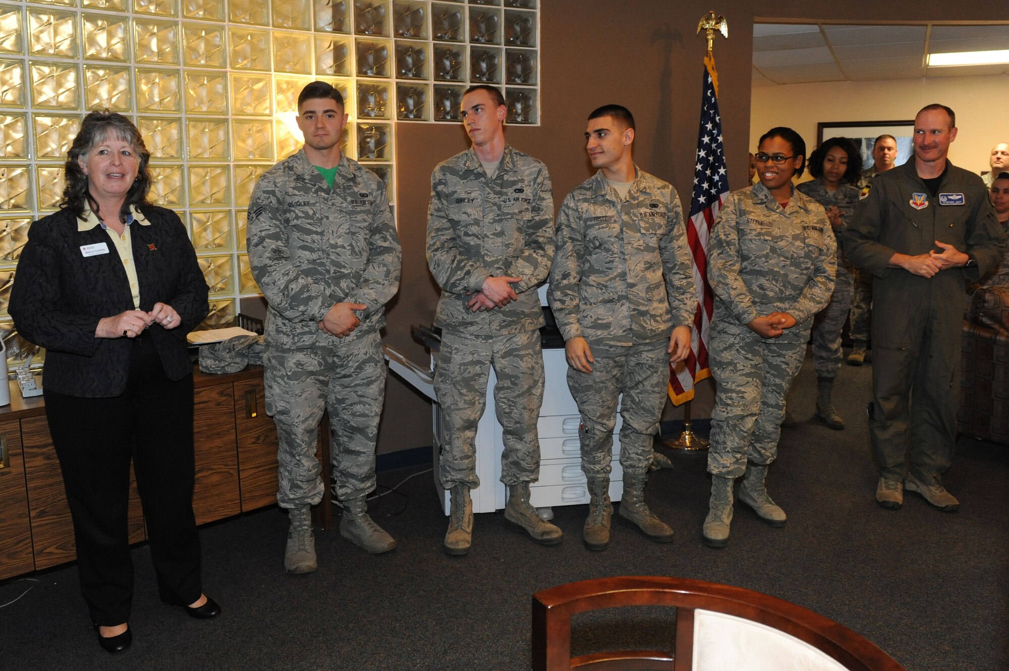 Four U.S. Air Force Airmen were recognized for their volunteer efforts by American Red Cross at Shaw Air Force Base, S.C., March 20, 2015. The Airmen volunteered to assist in the relocation of Shaw’s American Red Cross office from the 20th Mission Support Group building to the Airman and Family Readiness building. All four were coined by Nancy Cataldo, service to armed forces and international services officer, for their efforts in moving the office in one day. (U.S. Air Force photo by Senior Airman Diana M. Cossaboom/Released)