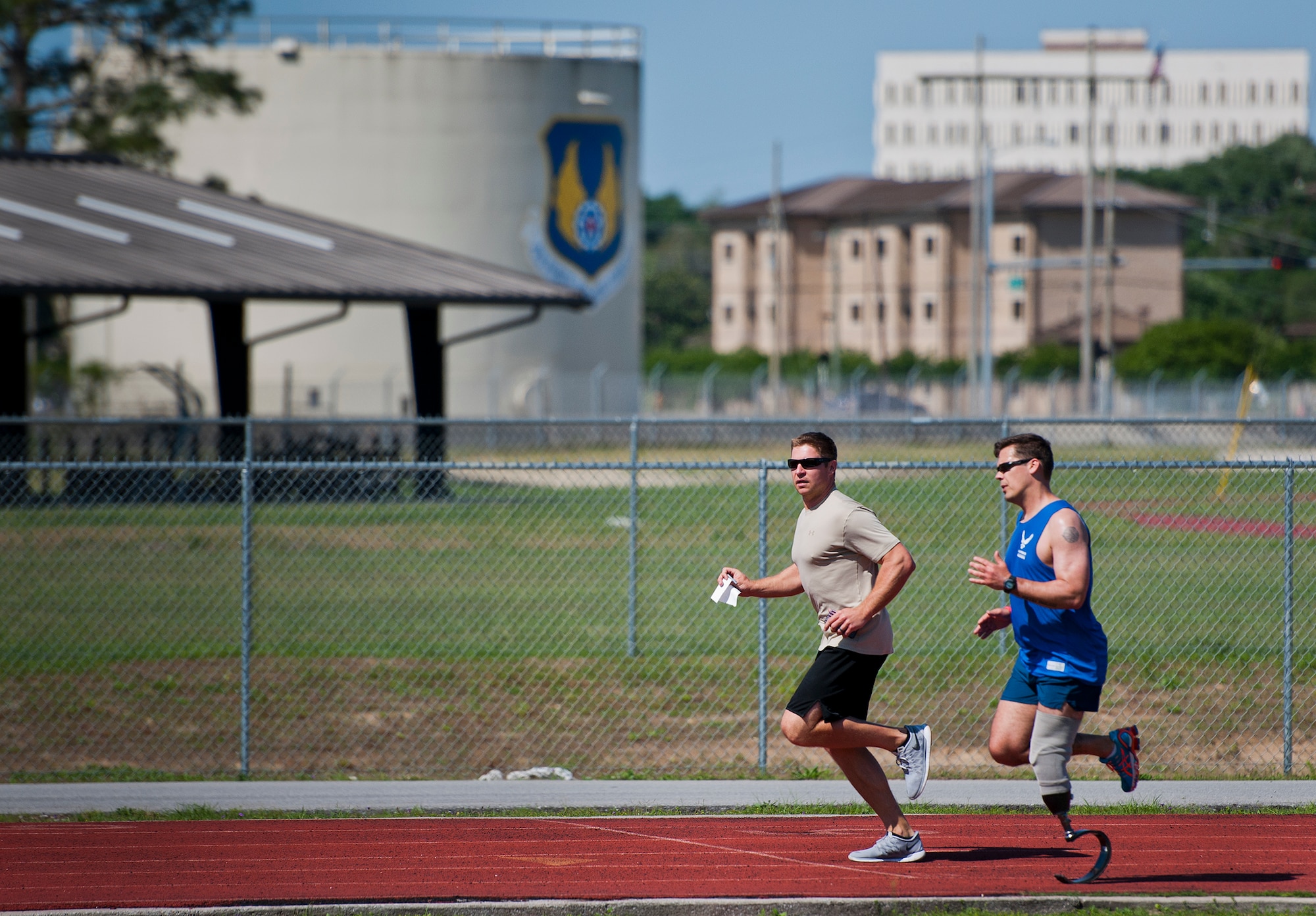 Master Sgt. Chris Ramakka, an active-duty Air Force Wounded Warrior athlete, runs around the track with during the fourth day of the Warrior Games training camp at Eglin Air Force Base, Fla., April 21. The five-day training camp for the Air Force’s athletes serves as their last practice session before the Warrior Games June 19-28. (U.S. Air Force photo/Samuel King Jr.)