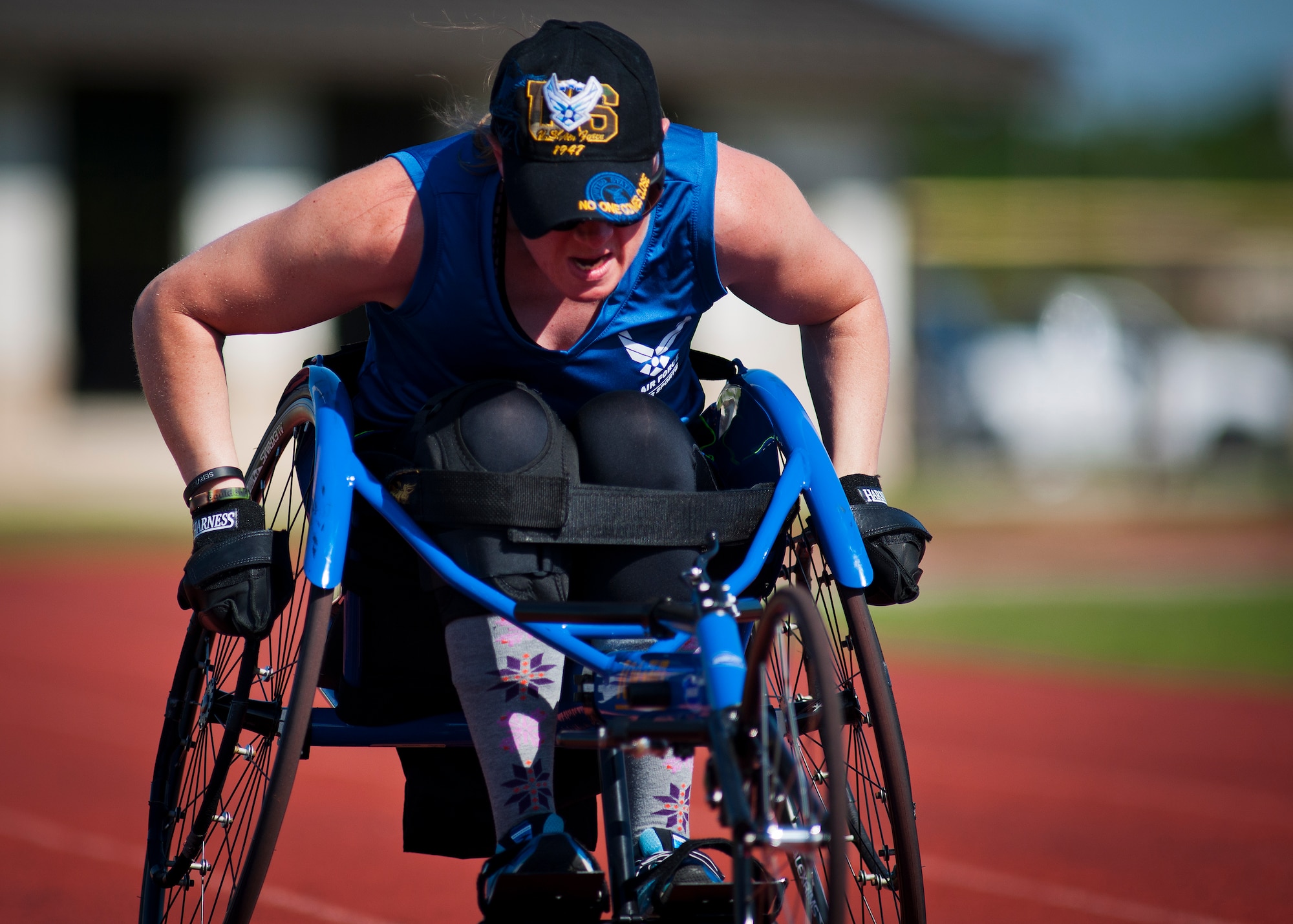 Melissa Gonzales, an Air Force Wounded Warrior athlete, gathers speed as she rolls down the track in a sport-chair during the fourth day of the Warrior Games training camp at Eglin Air Force Base, Fla., April 21. The five-day training camp for the Air Force’s athletes serves as their last practice session before the Warrior Games June 19-28. (U.S. Air Force photo/Samuel King Jr.)