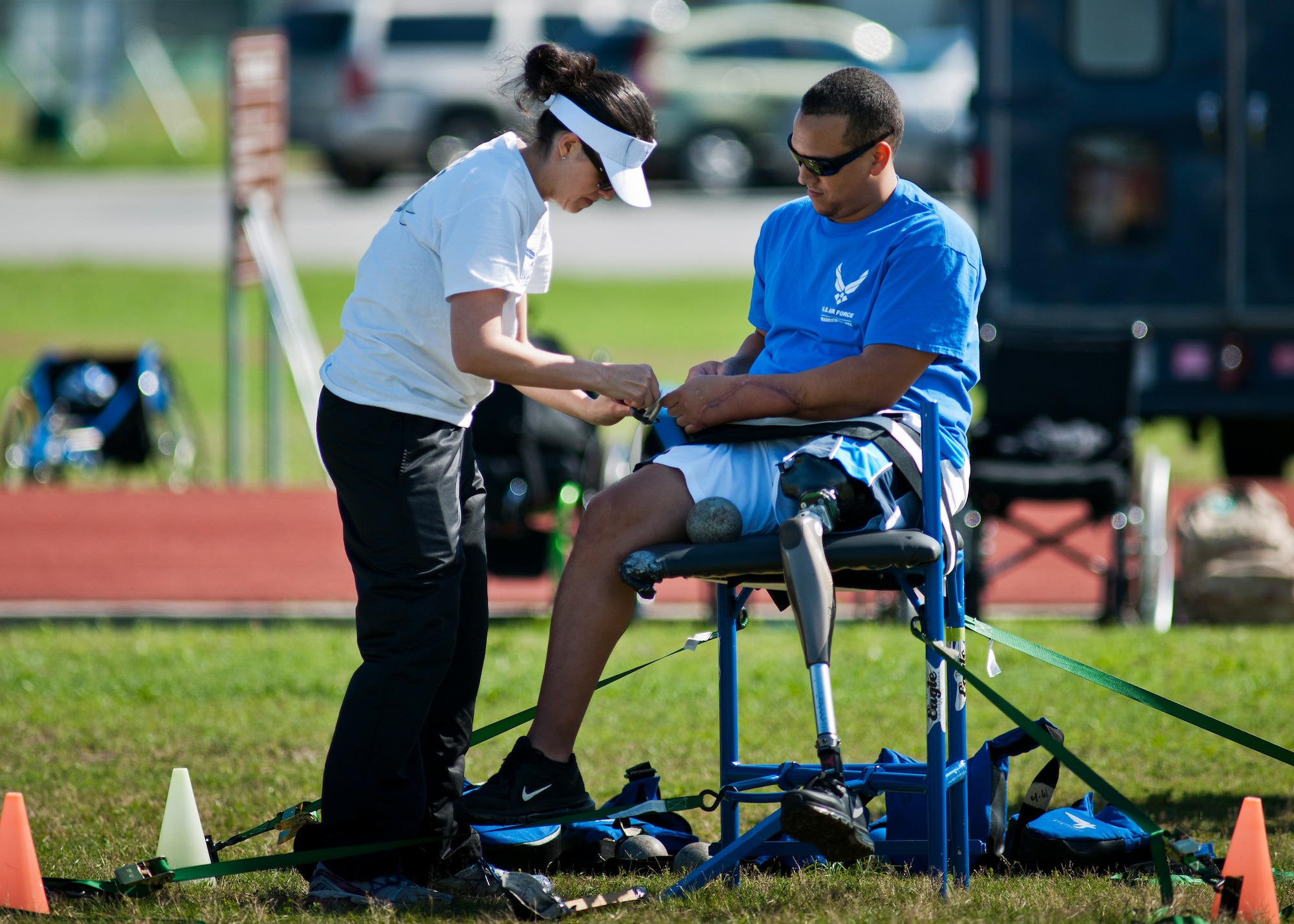Brian Williams, an Air Force Wounded Warrior athlete, gets secured to the chair before trying the sitting shot put method during the fourth day of the Warrior Games training camp at Eglin Air Force Base, Fla., April 21. The five-day training camp for the Air Force’s athletes serves as their last practice session before the Warrior Games June 19-28. (U.S. Air Force photo/Samuel King Jr.)