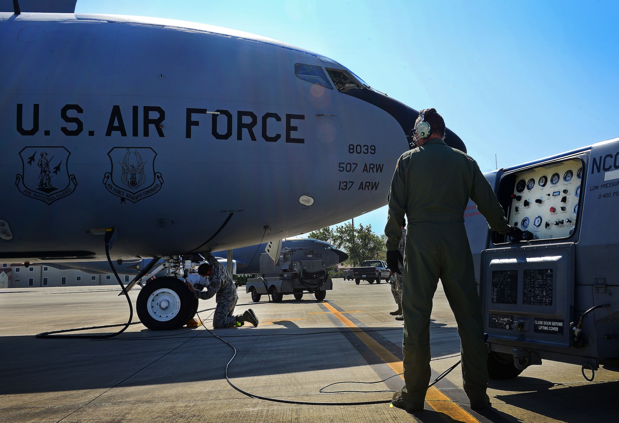 (From left) U.S. Air Force Tech. Sgt. John Sanders pumps air into a KC-135 Stratotanker’s tire while Senior Airman Tim Hardy controls a gauge, April 21, 2015, at Aviano Air Base, Italy. More than 50 Air Force Reservists including chaplains, crew chiefs and force support worked with Aviano units during their two-week required annual tour. Sanders and Hardy are crew chiefs with the 507th Air Refueling Wing Aircraft Maintenance Squadron from Tinker Air Force Base, Okla., (U.S. Air Force photo by Senior Airman Matthew Lotz/Released)