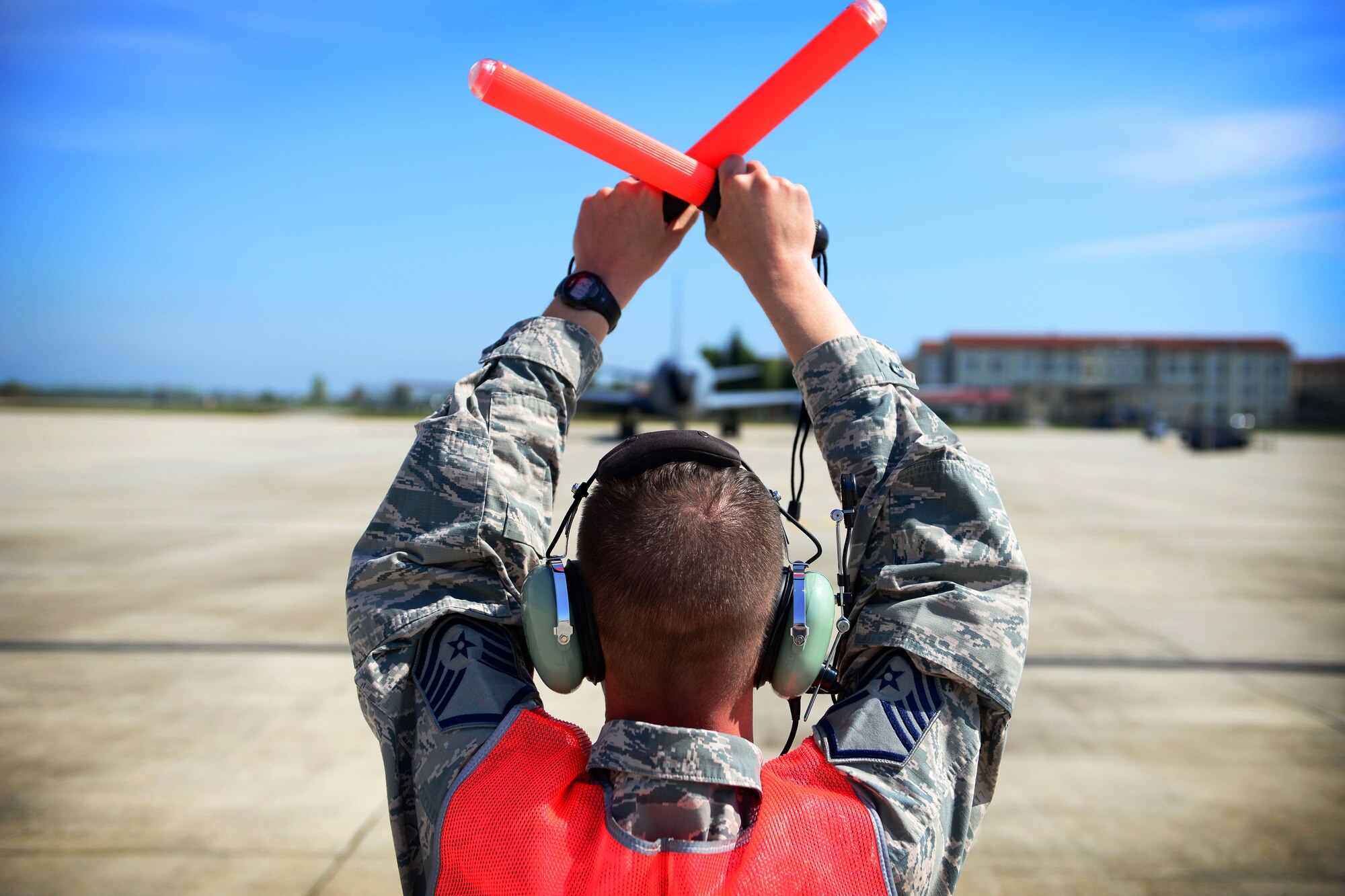 U.S. Air Force Master Sgt. Harold Strawderman, 507th Air Refueling Wing from Tinker Air Force Base, Okla., Aircraft Maintenance Squadron productions superintendent, guides a KC-135 Stratotanker onto a taxiway, April 21, 2015, at Aviano Air Base, Italy. The 507th ARW’s KC-135s allowed the 31st Fighter Wing’s F-16 Fighting Falcons to practice in-flight refueling missions. (U.S. Air Force photo by Senior Airman Matthew Lotz/Released)