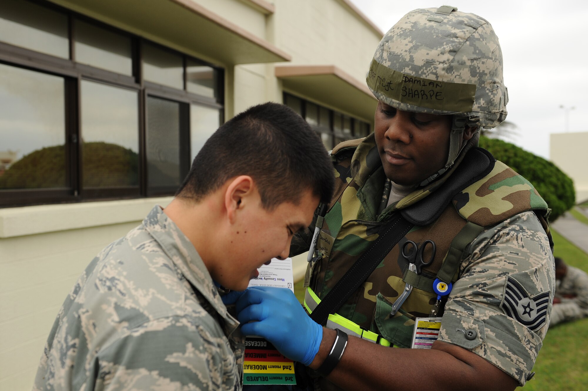 U.S. Air Force Tech. Sgt. Damian Sharpe, 18th Medical Operations Squadron maternal and child flight chief, checks Airman 1st Class Jimmy Thompson, 18th Component Maintenance Squadron aerospace propulsion technician, for injuries following a simulated vehicle accident on Kadena Air Base, Japan, April 21, 2015. The scenario was held in support of the base’s mission focused exercise, and was designed to test the reaction time, knowledge of procedures and interoperability of the 18th Wing’s first responders. (U.S. Air Force photo by Airman 1st Class Zade C. Vadnais)
