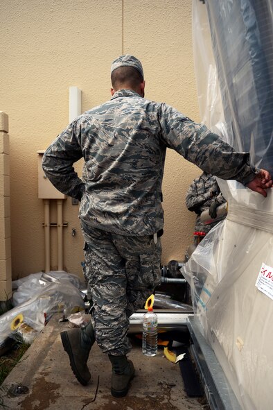 Airman Sean Bialecky, 374th Civil Engineer Squadron Heating Ventilation and Air Conditioning Airman, observes an installation of insulation and shielding for pipes, April 21, 2015 at Yokota Air Base, Japan. Bialecky’s supervisor was demonstrated the proper techniques for accomplishing this task. (U.S. Air Force photo by Airman 1st Class Delano Scott/Released)