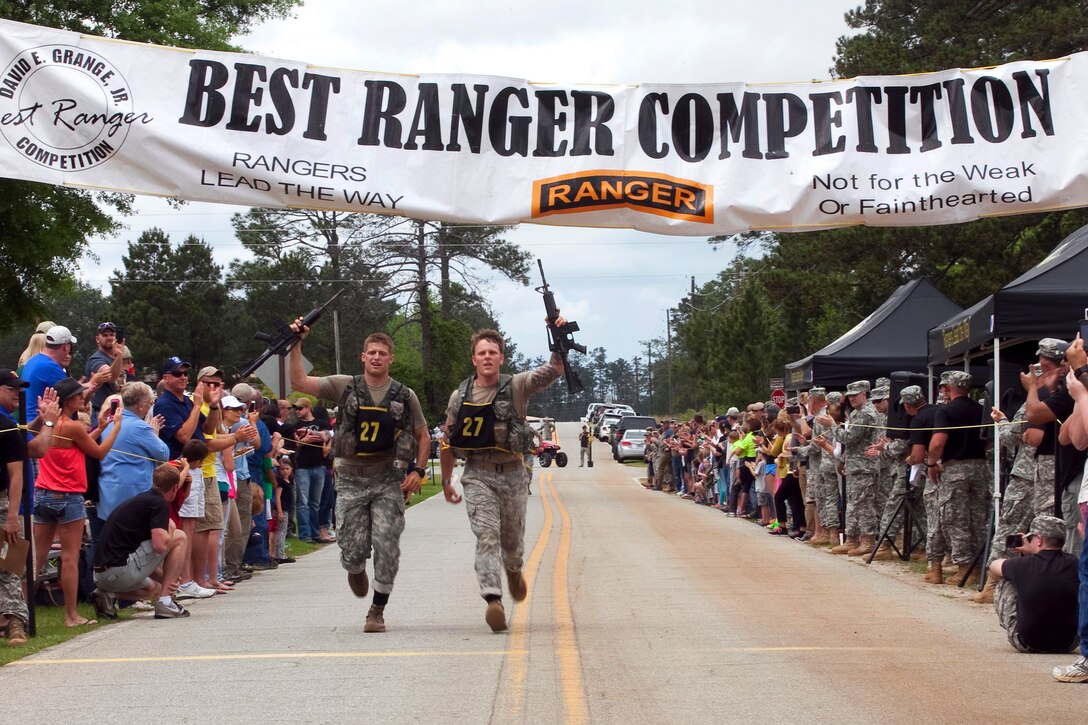 Army Staff Sgt. Philip Jewah and Sgt. Thomas Malphrus, both from the 75th Ranger Regiment, complete the buddy run to conclude the 2015 Best Ranger Competition, April 12, 2015, at Fort Benning, Ga. The team finished third overall in what was their first attempt at the competition.