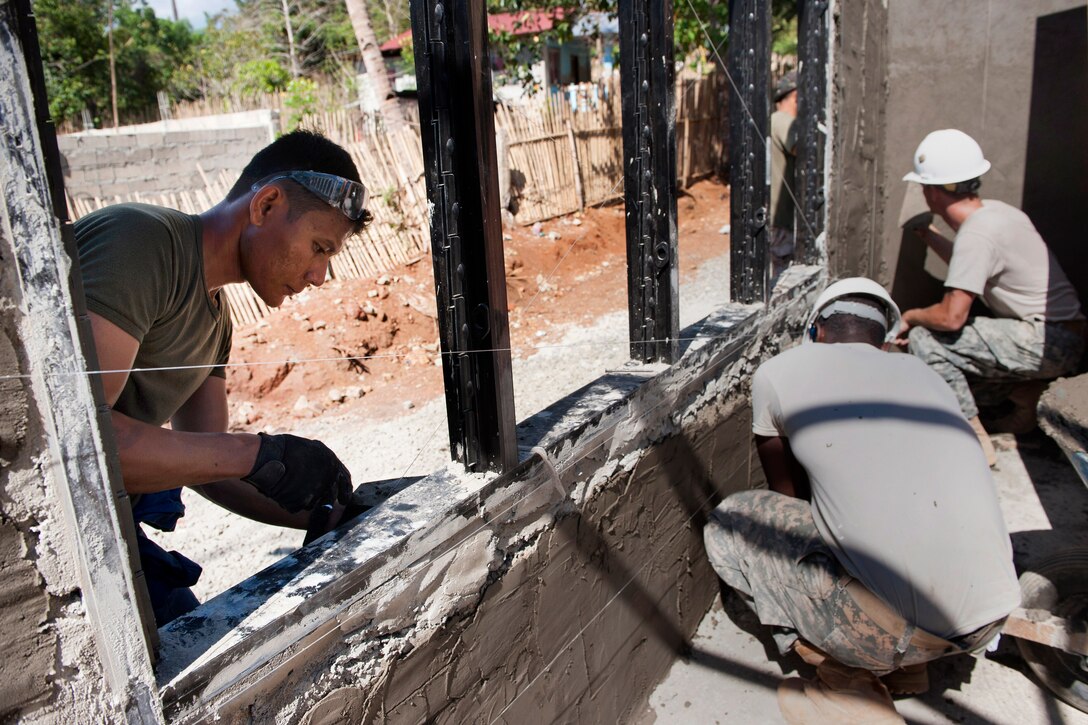 Philippine air force Sgt. Rodante Suplito, left, and U.S. Army Spcs. Jerome Ramsey and Poole Spencer construct classrooms for Santa Lourdes National High School during exercise Balikatan 2015 in Puerto Princesa City, Palawan, Philippines, April 21, 2015. Suplito is an electrical specialist assigned to the 570th Composite Tactical Wing and Ramsey and Spencer are assigned to the 643rd Engineer Company, 84th Engineer Battalion, 130th Engineer Brigade.