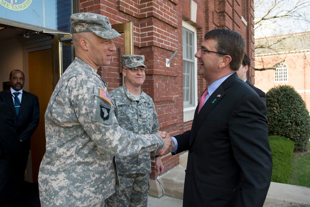 Defense Secretary Ash Carter, right, exchanges greetings with Army Col. Johnny Davis, commander of the 3rd U.S. Infantry Regiment, upon arriving on Joint Base Myer-Henderson Hall, Va., to participate in an Army roundtable on sexual assault and sexual harassment prevention and response, April 22, 2015.